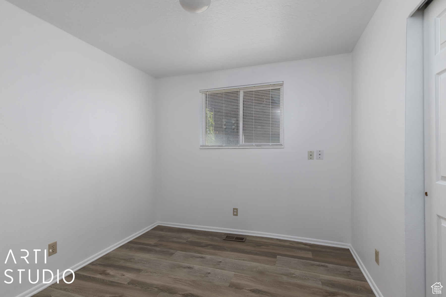 Spare room with dark hardwood / wood-style floors