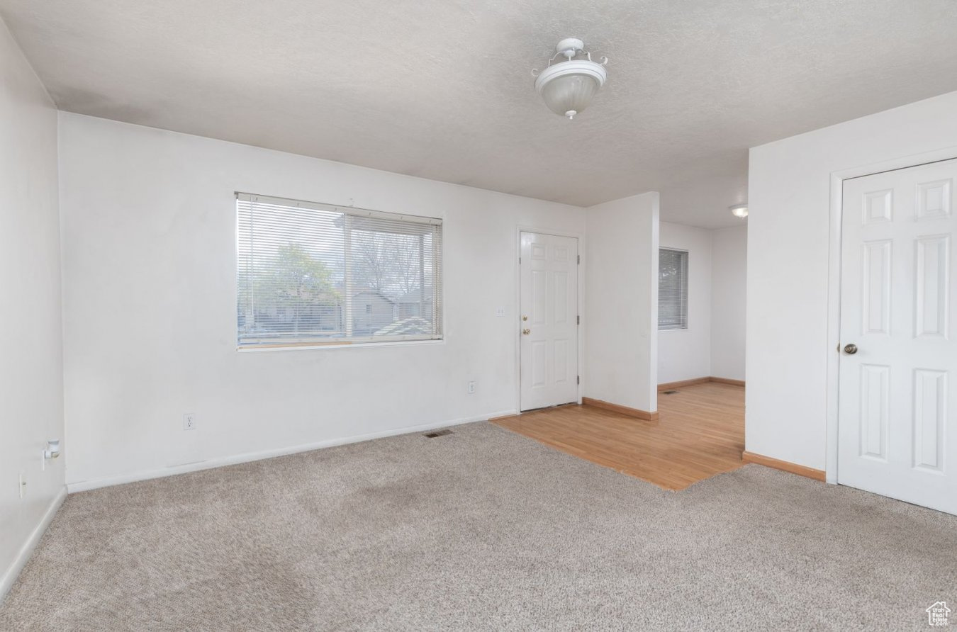 Unfurnished room with light colored carpet