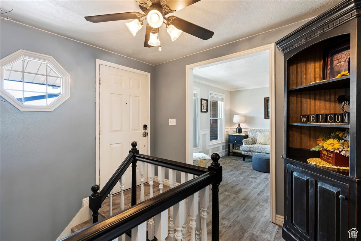 Corridor with a healthy amount of sunlight and hardwood / wood-style floors