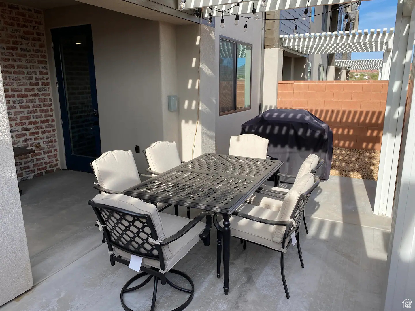 View of patio featuring grilling area and a pergola