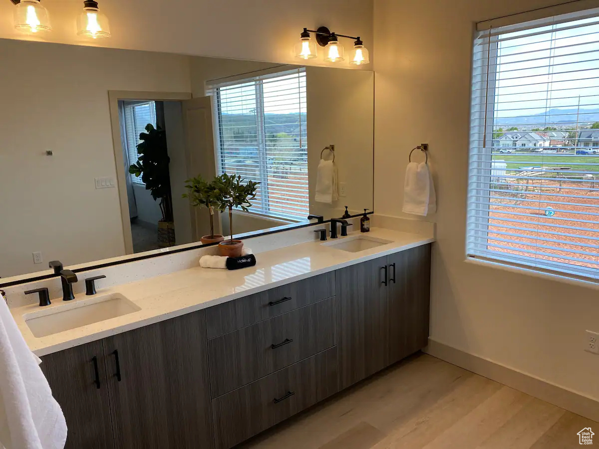 Bathroom featuring wood-type flooring and double sink vanity