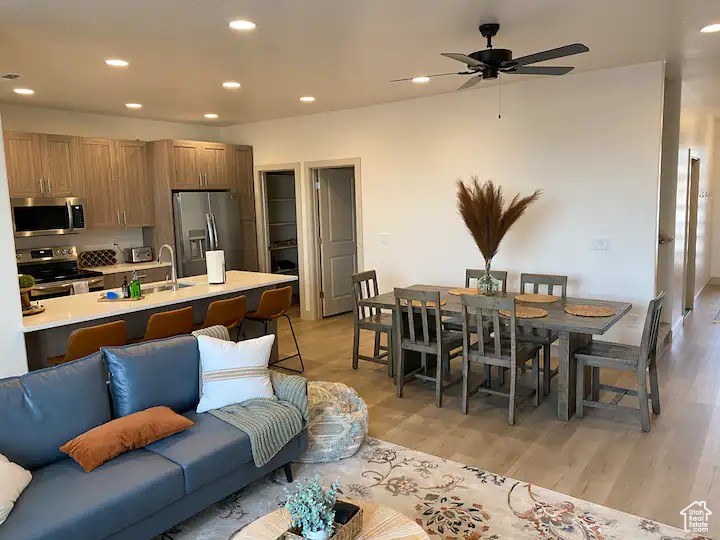 Interior space featuring light hardwood / wood-style flooring, sink, and ceiling fan