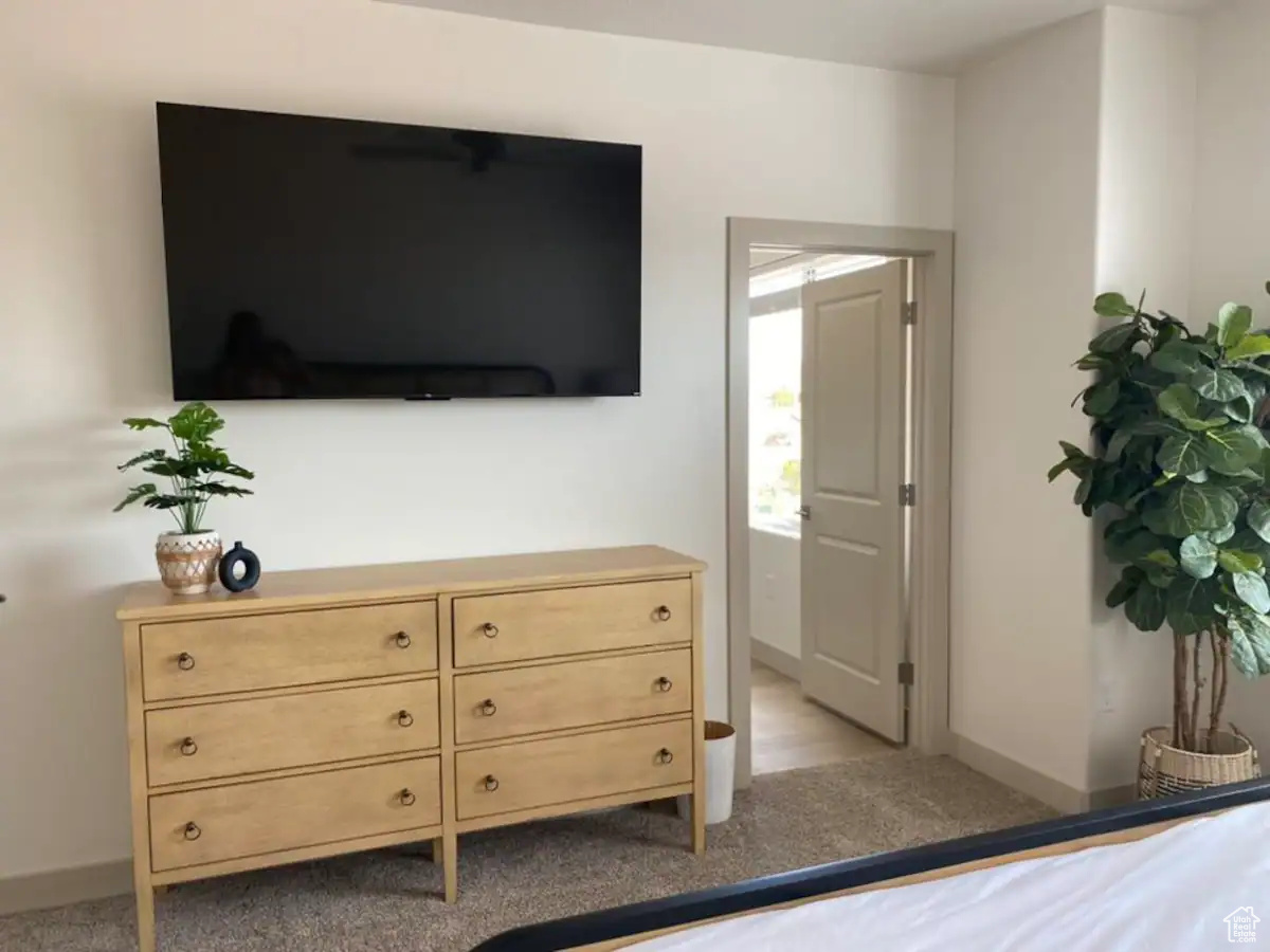 Bedroom featuring light carpet