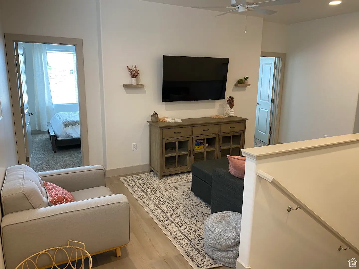 Living room with ceiling fan and light wood-type flooring