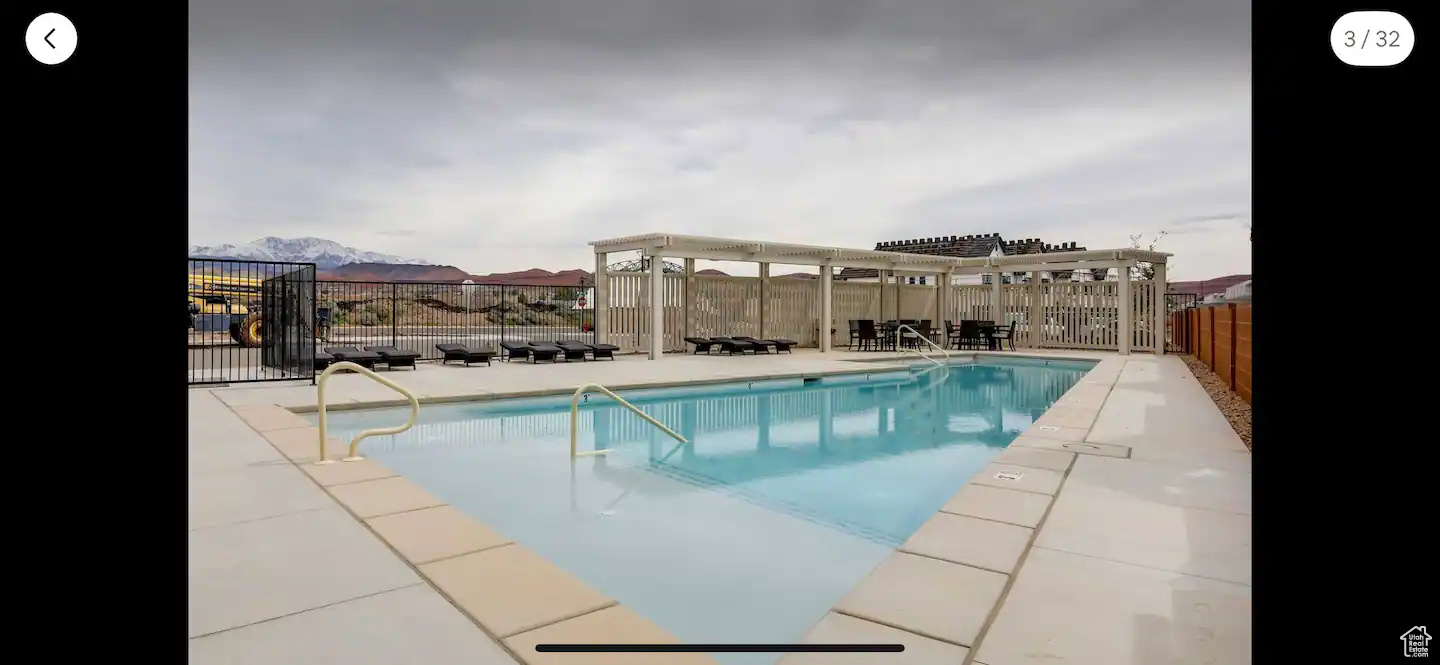 View of pool featuring a mountain view and a pergola