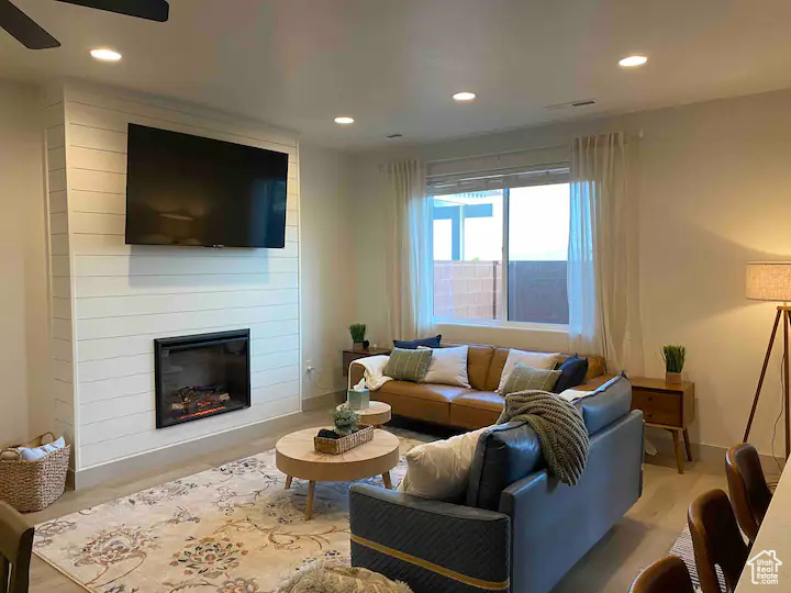 Living room with a fireplace and ceiling fan