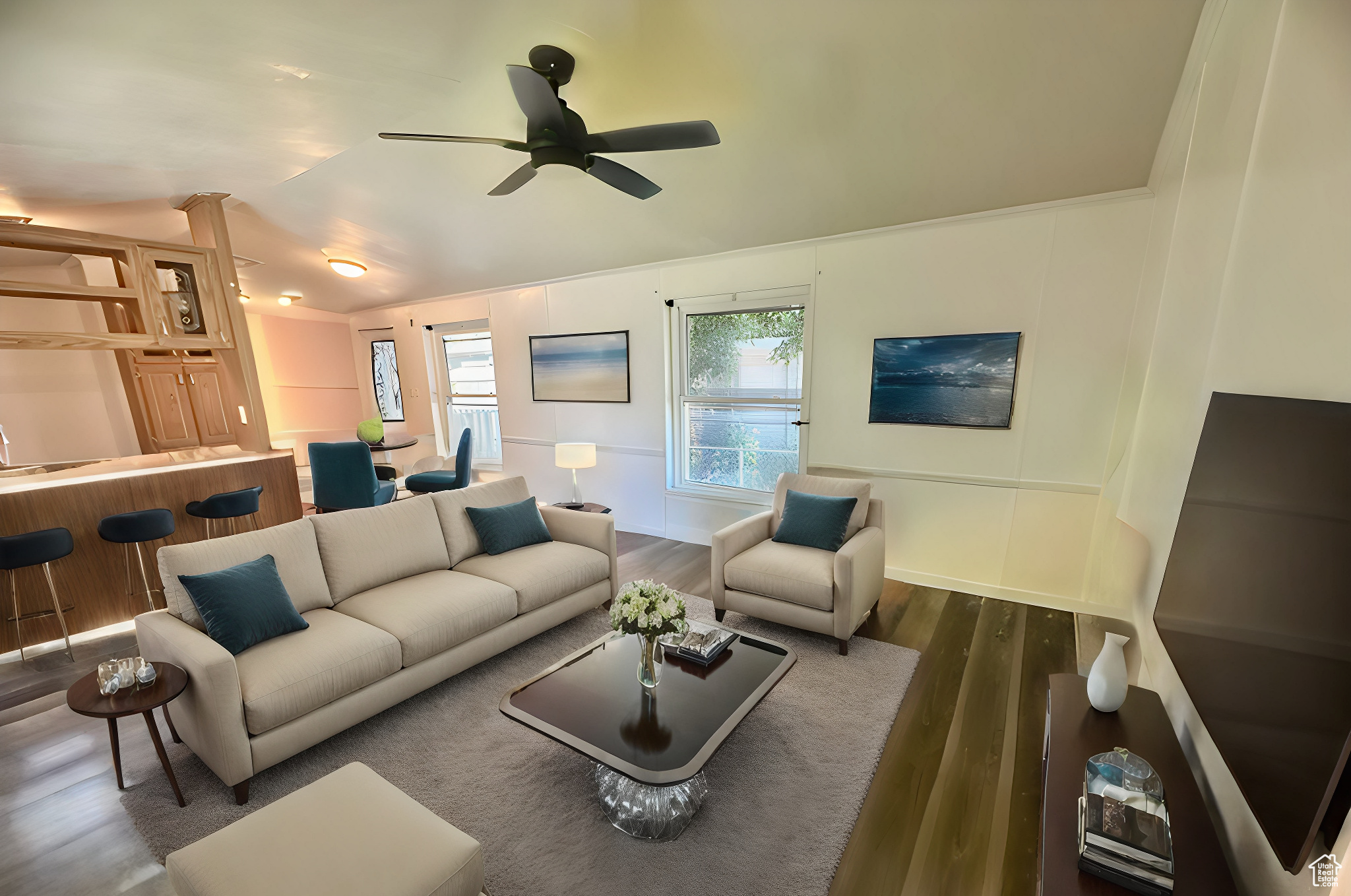 Living room featuring wood-type flooring and ceiling fan. Virtually staged