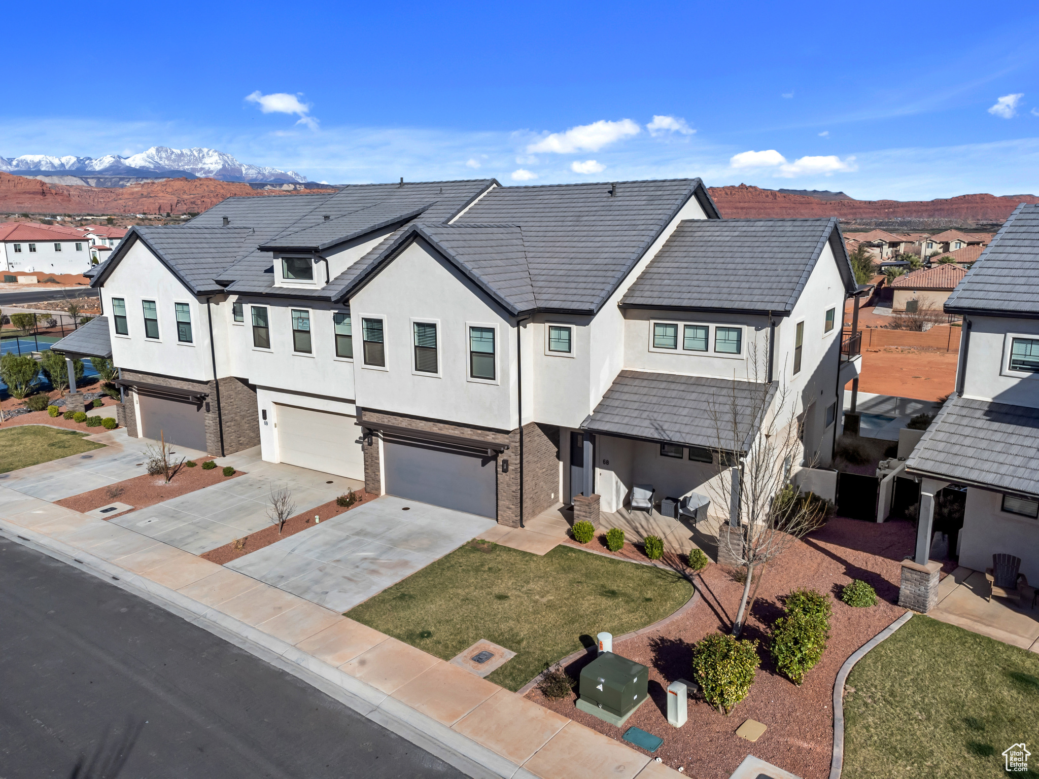 Multi unit property with a garage, a mountain view, and a front yard