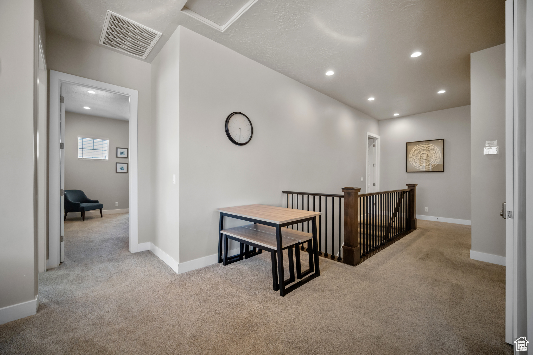 Hall with light colored carpet