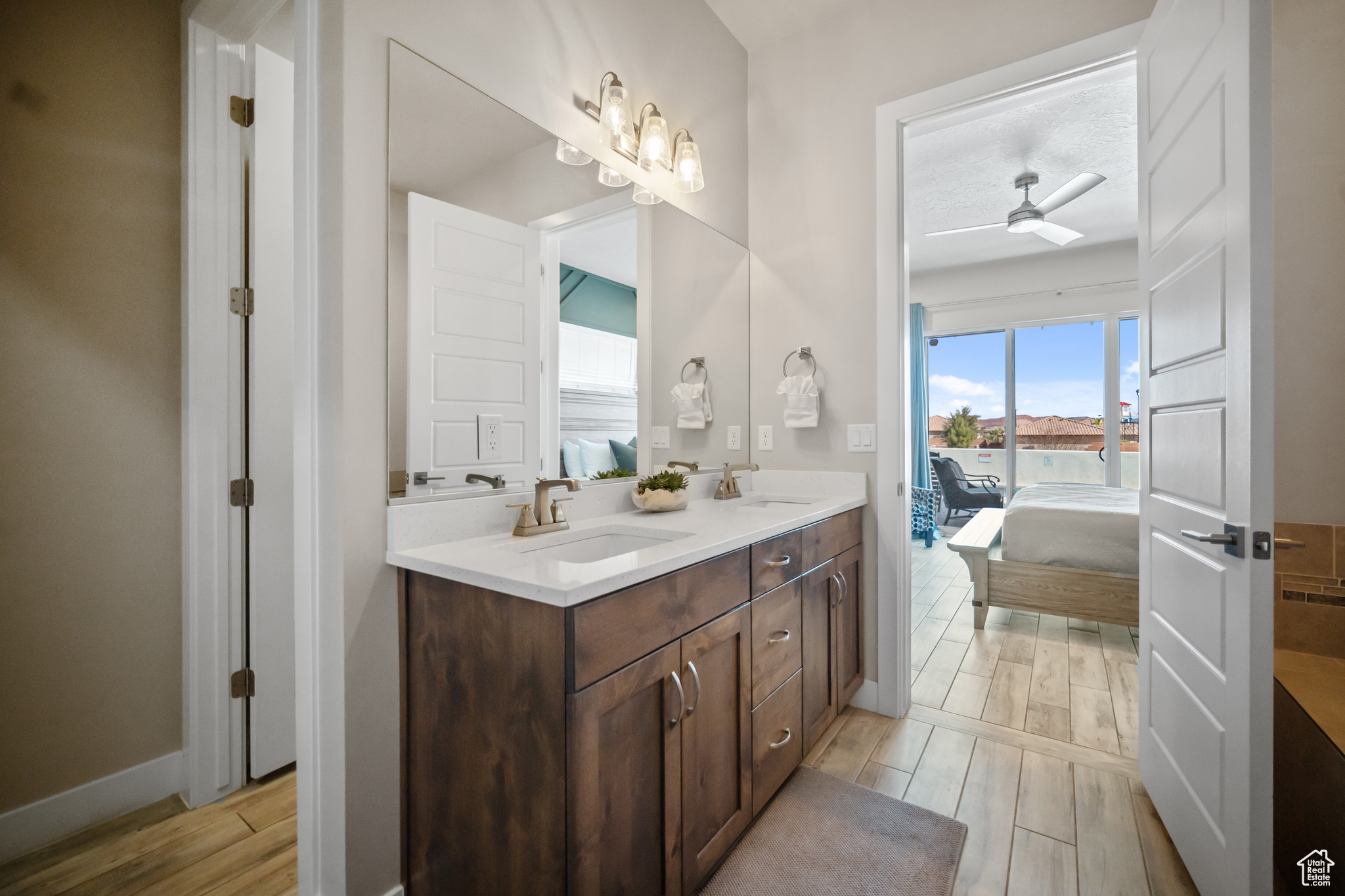 Bathroom with double sink vanity and ceiling fan