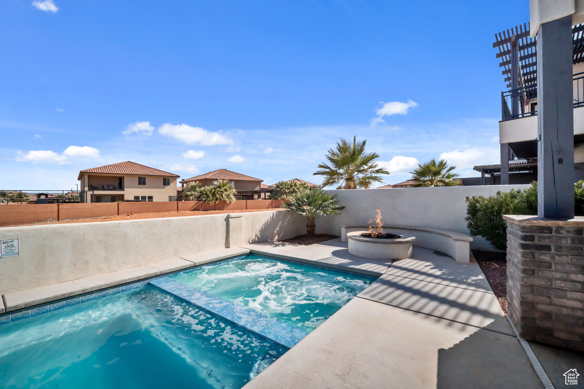 View of pool with a fire pit