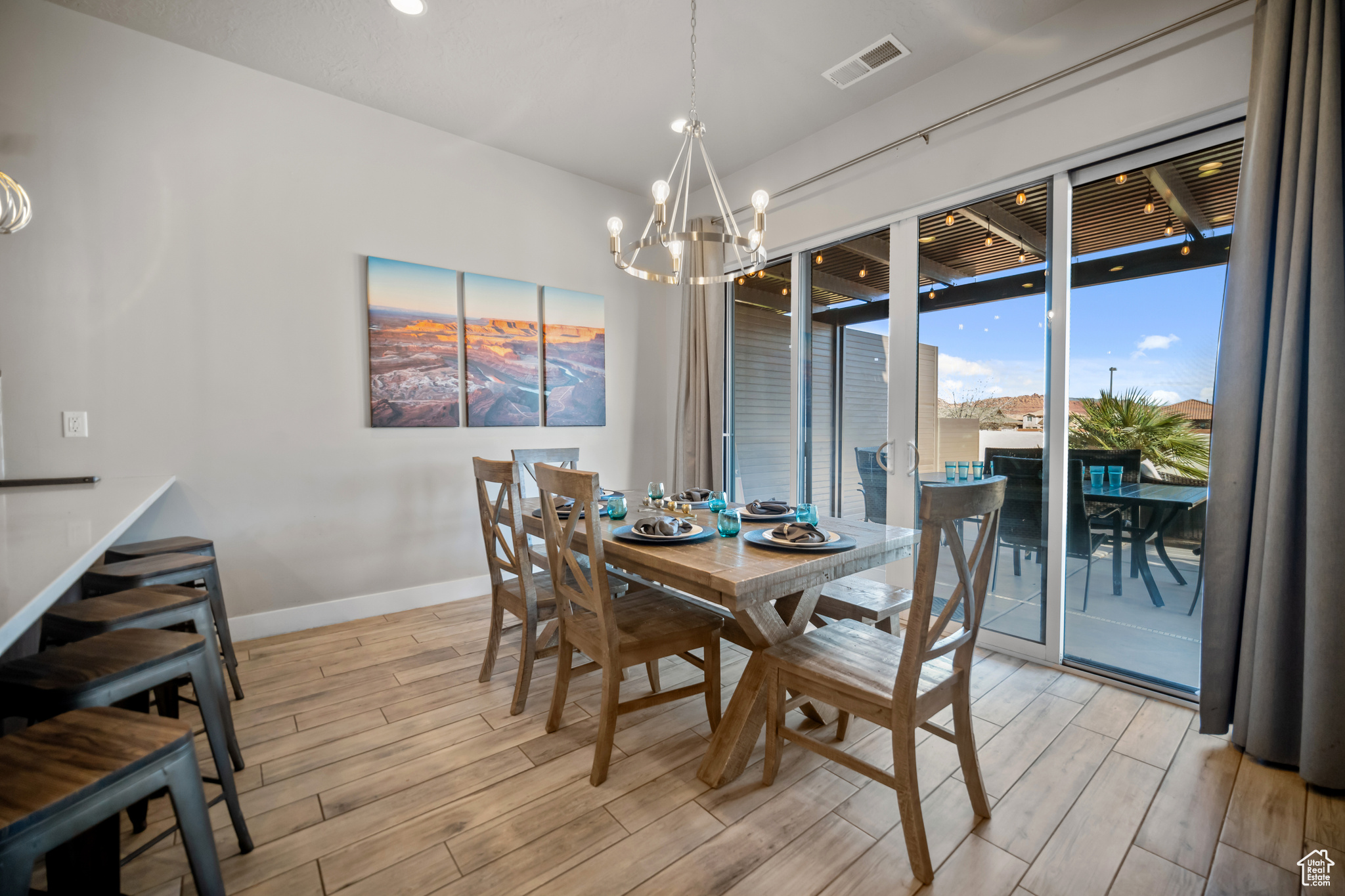 Dining room featuring light hardwood / wood-style floors and an inviting chandelier