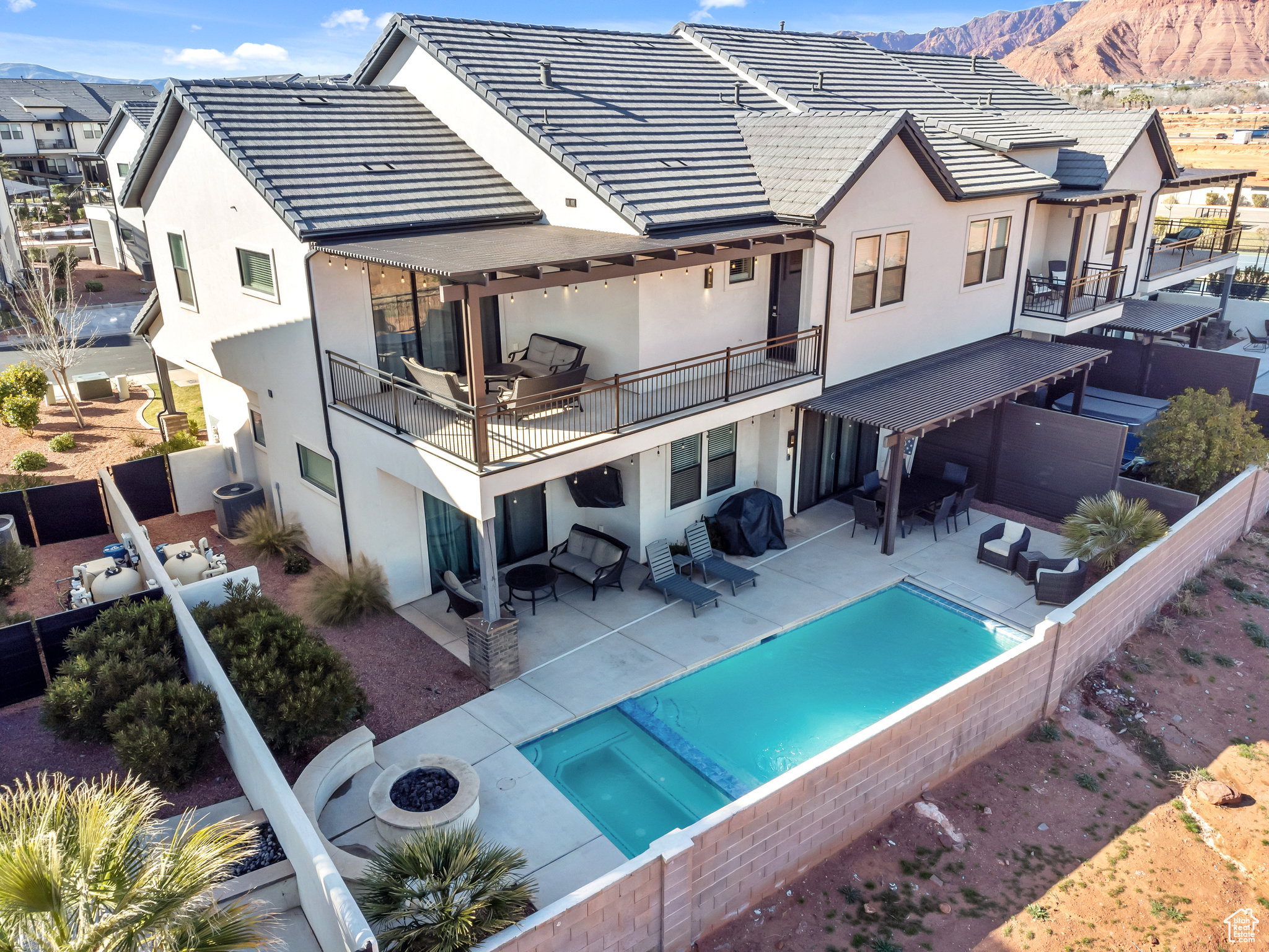 Back of house featuring a balcony, outdoor lounge area, a patio, and a mountain view