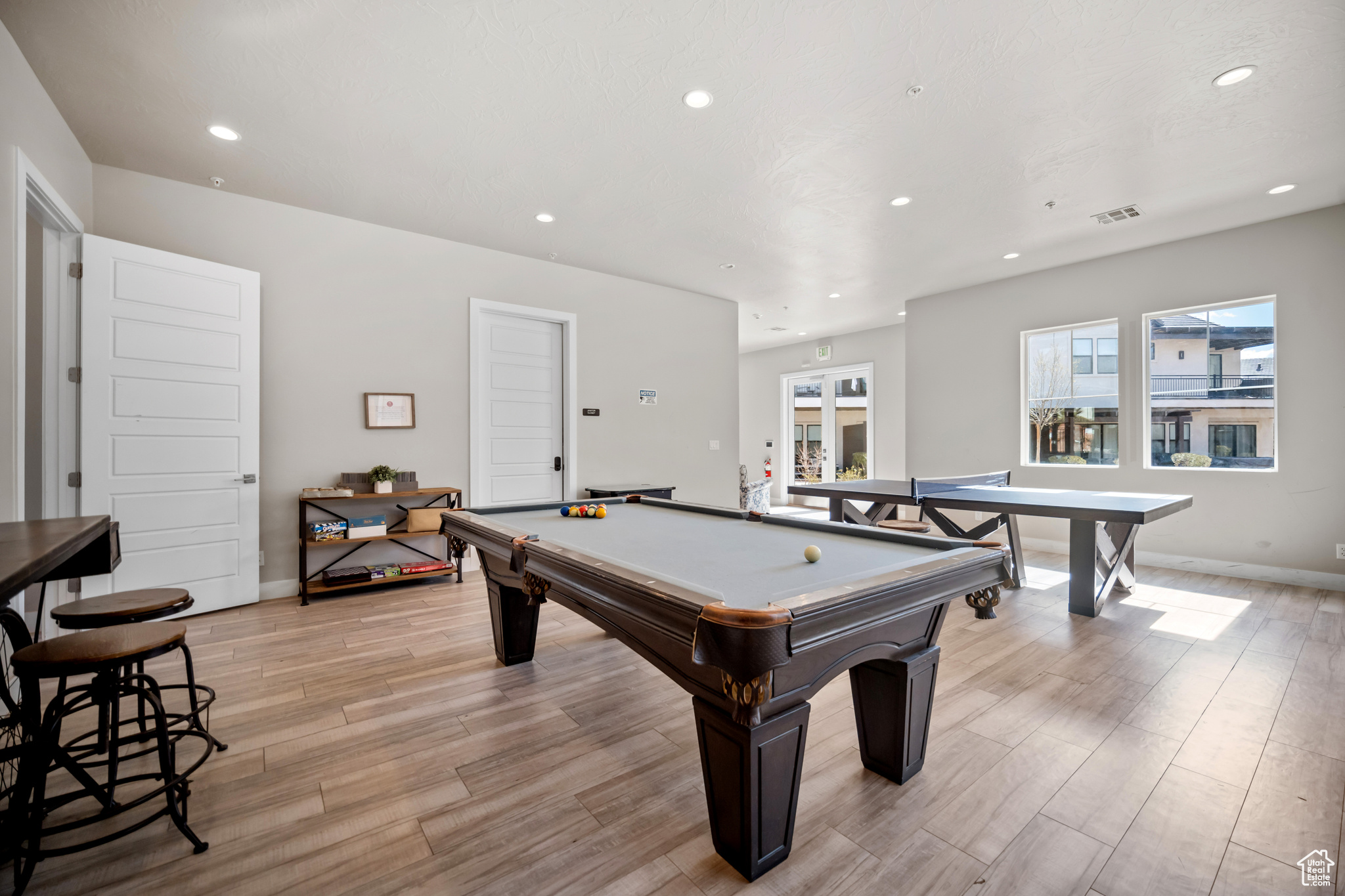 Playroom with light hardwood / wood-style floors and billiards