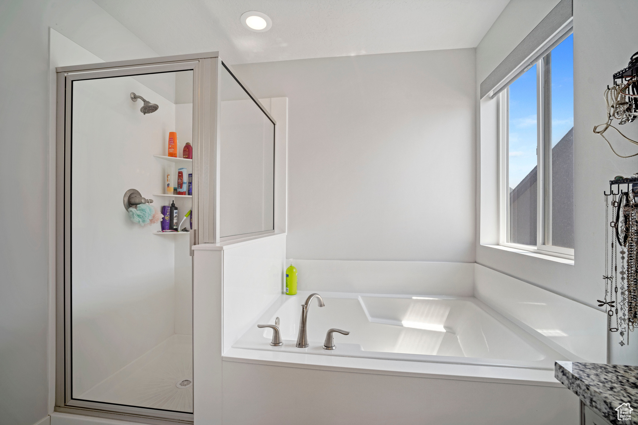 Bathroom featuring plus walk in shower and vanity