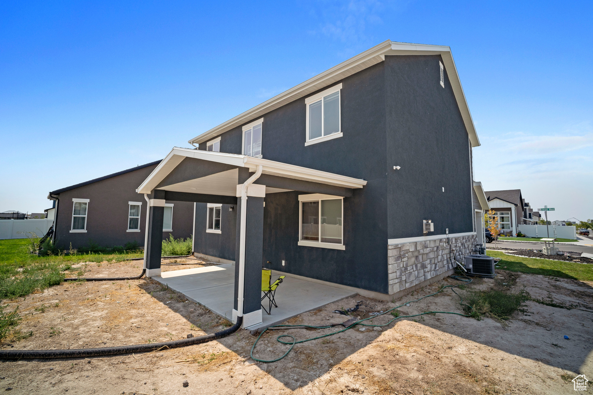 View of front of home featuring cooling unit and a patio