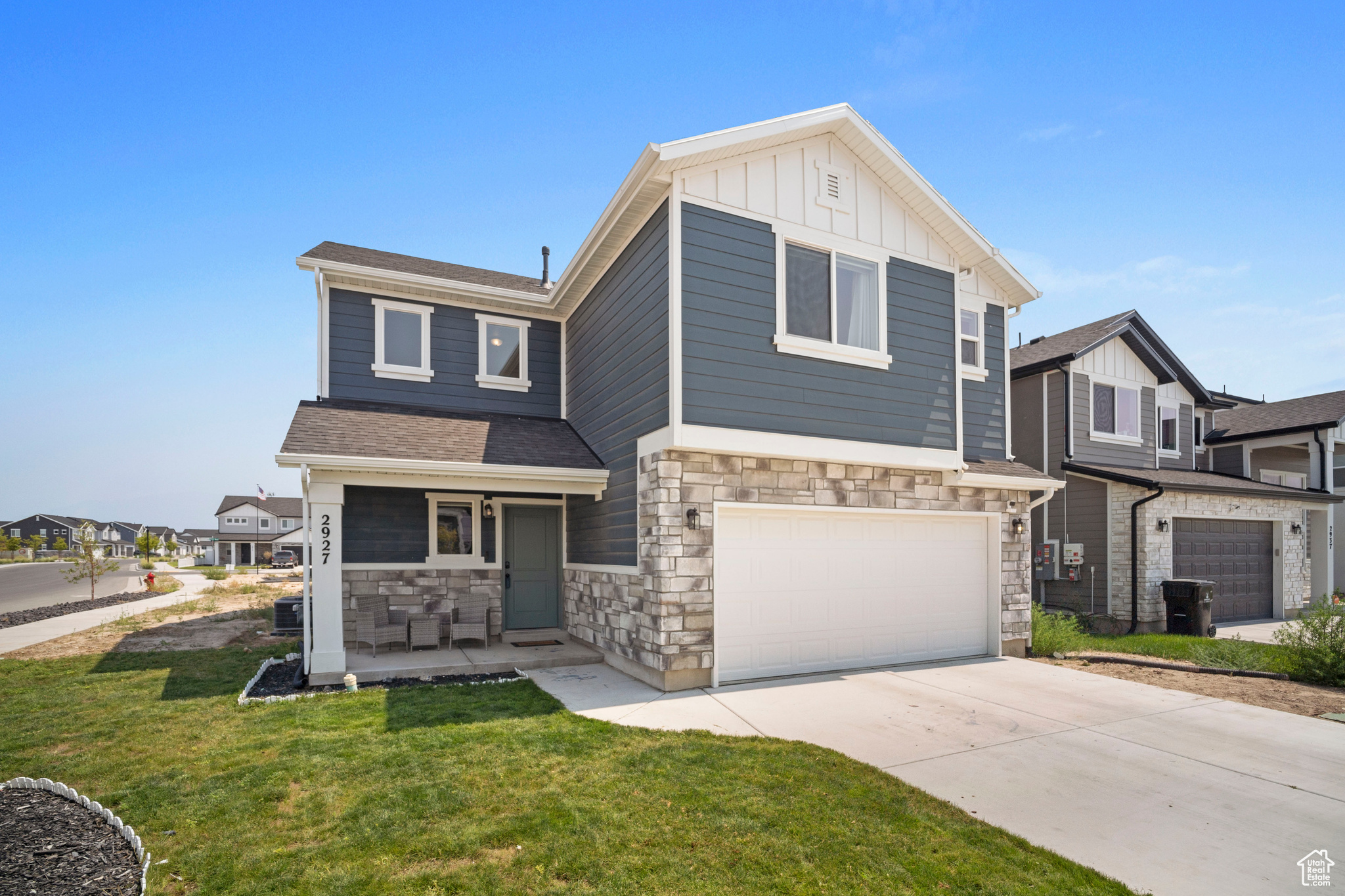 View of front facade featuring a garage and a front yard