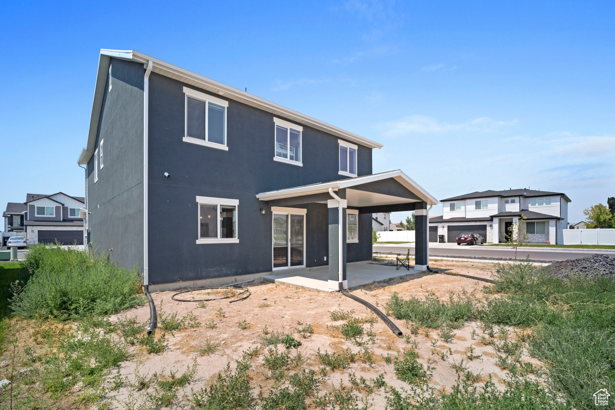 Rear view of house with a patio and a garage