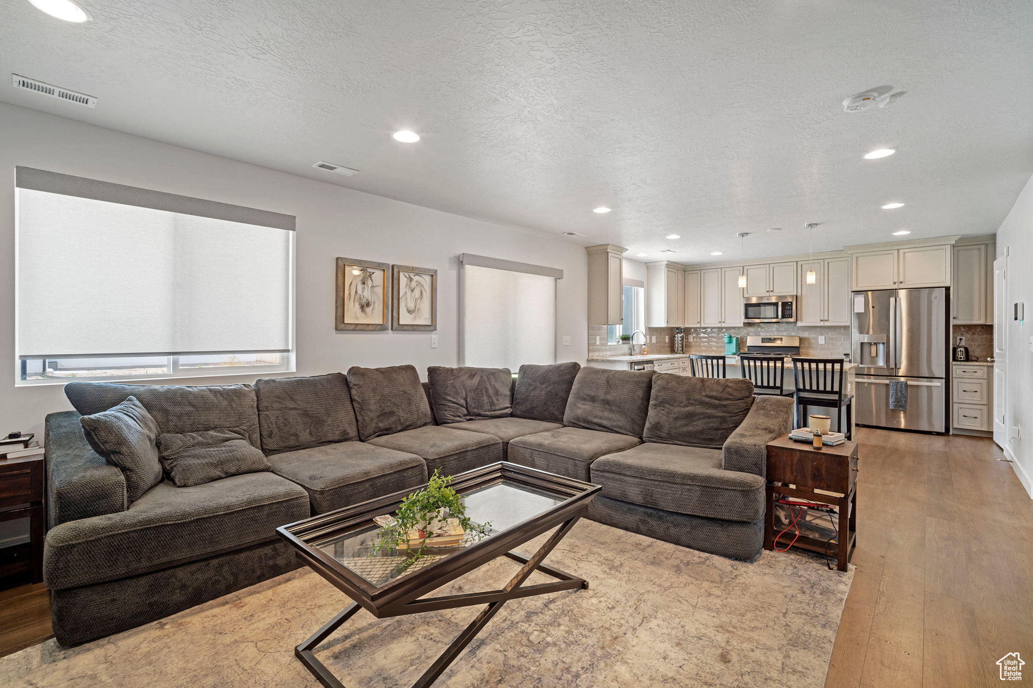 Living room featuring light hardwood / wood-style floors and a textured ceiling