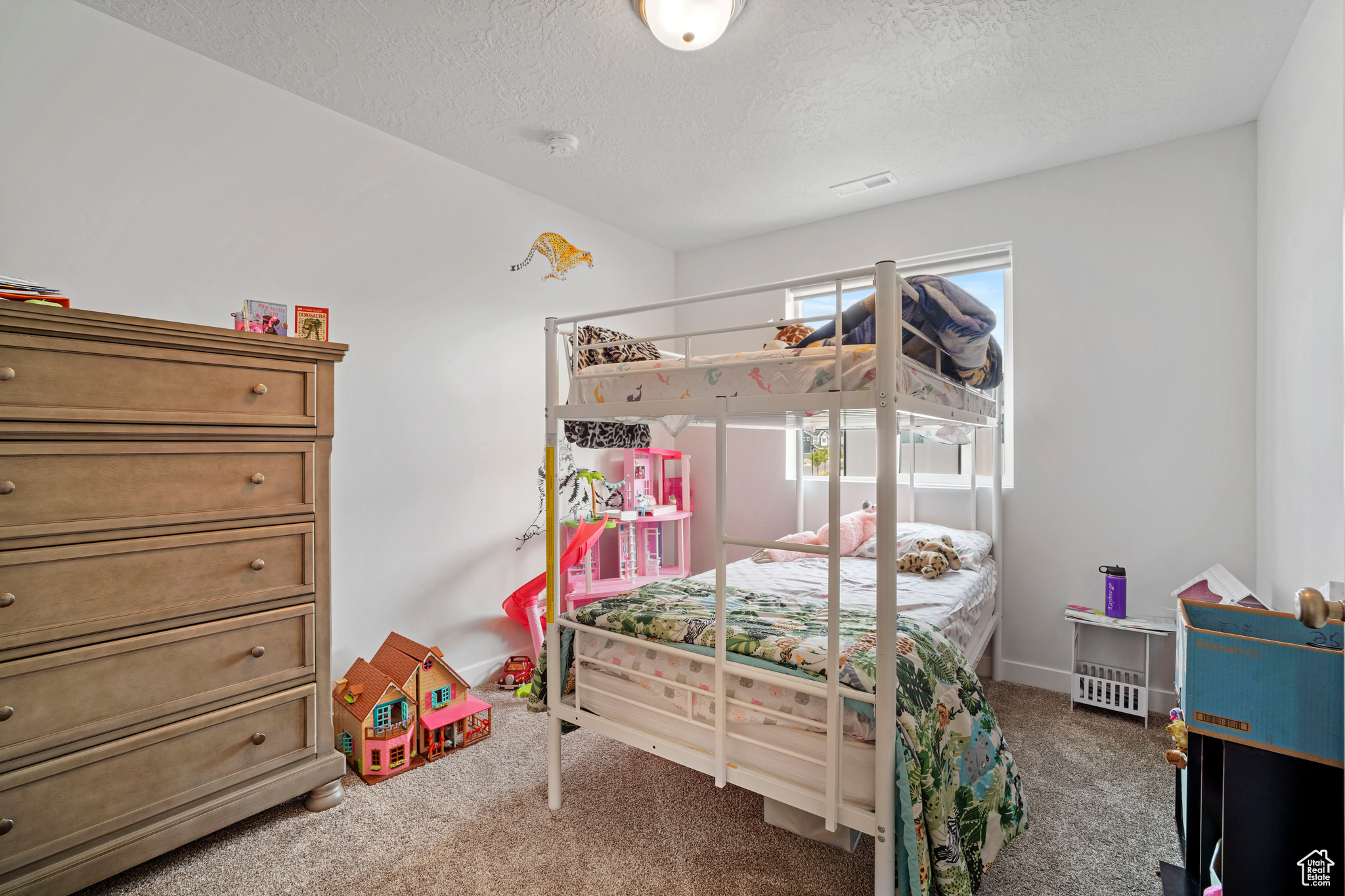 Carpeted bedroom featuring a textured ceiling