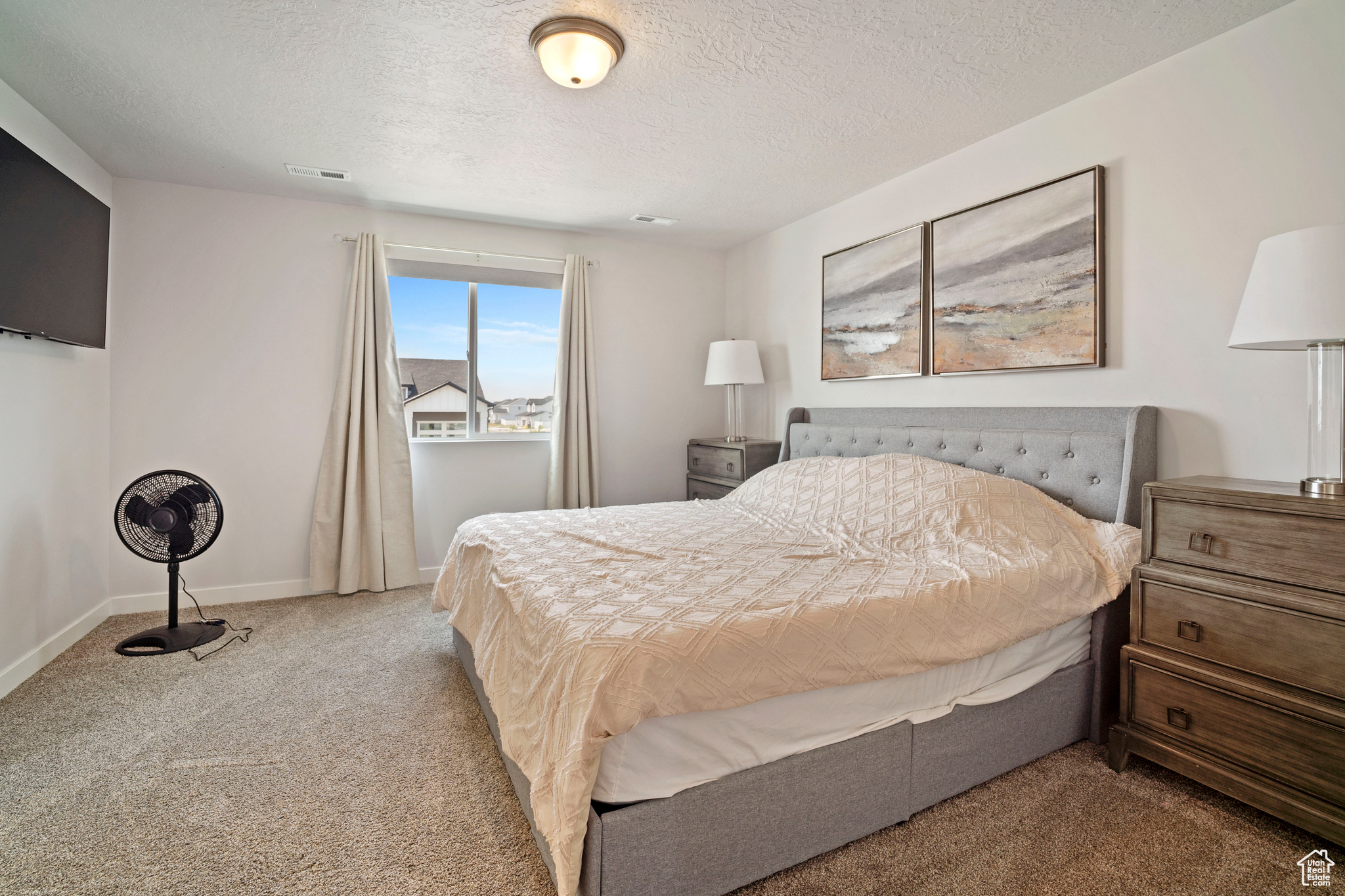 Carpeted bedroom featuring a textured ceiling