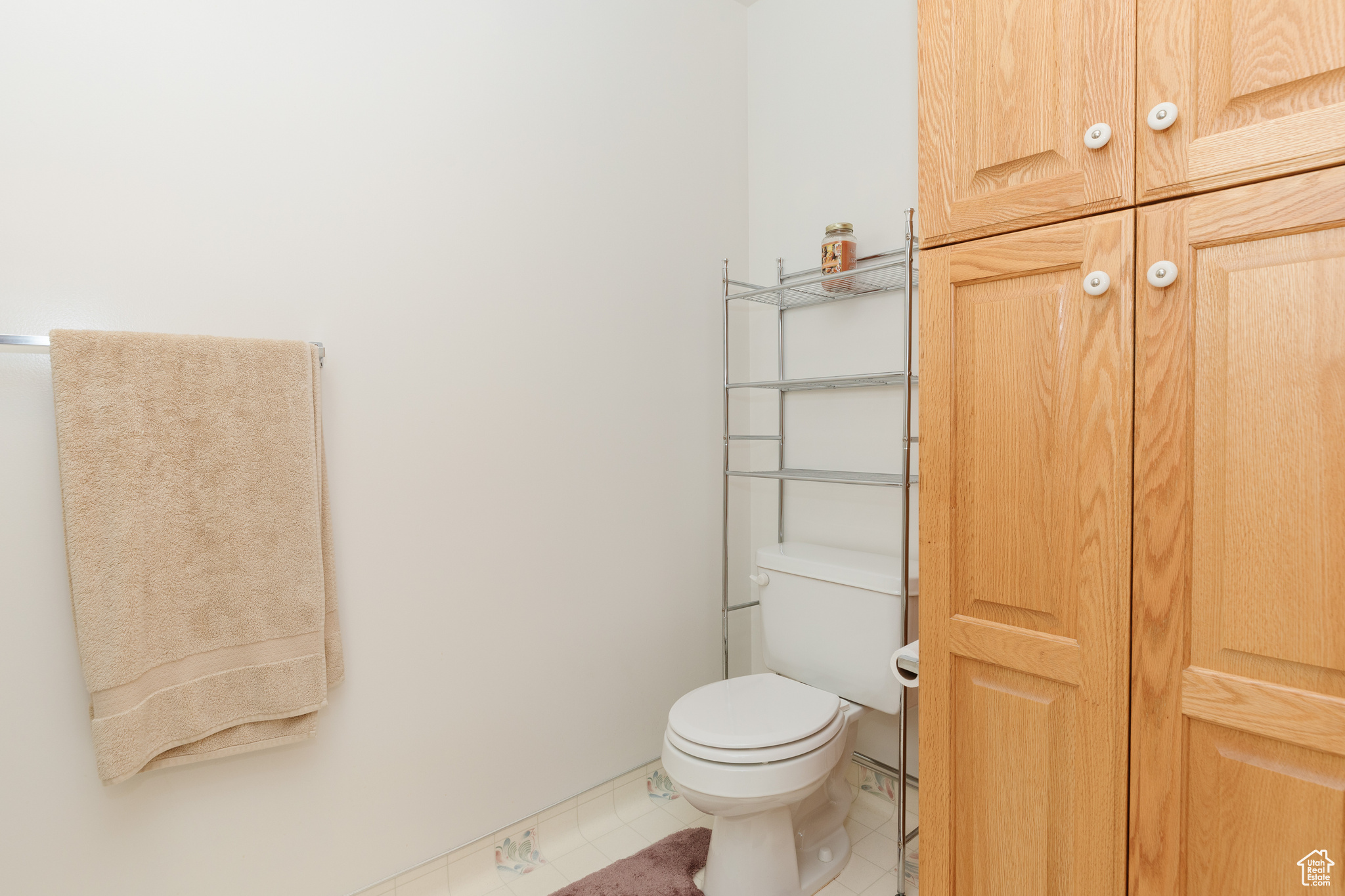 Bathroom featuring tile patterned flooring and toilet