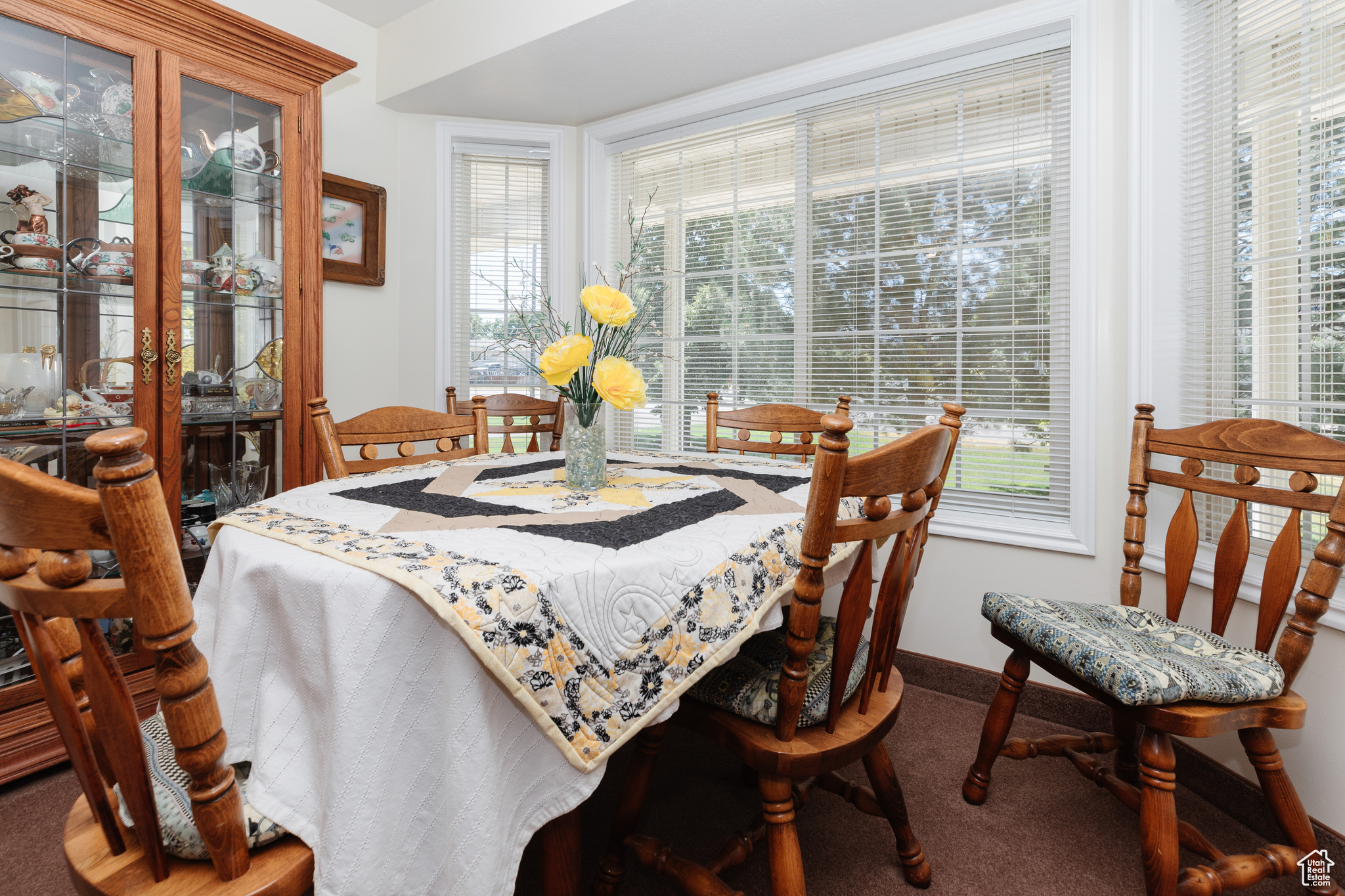 Dining room with plenty of natural light and carpet floors