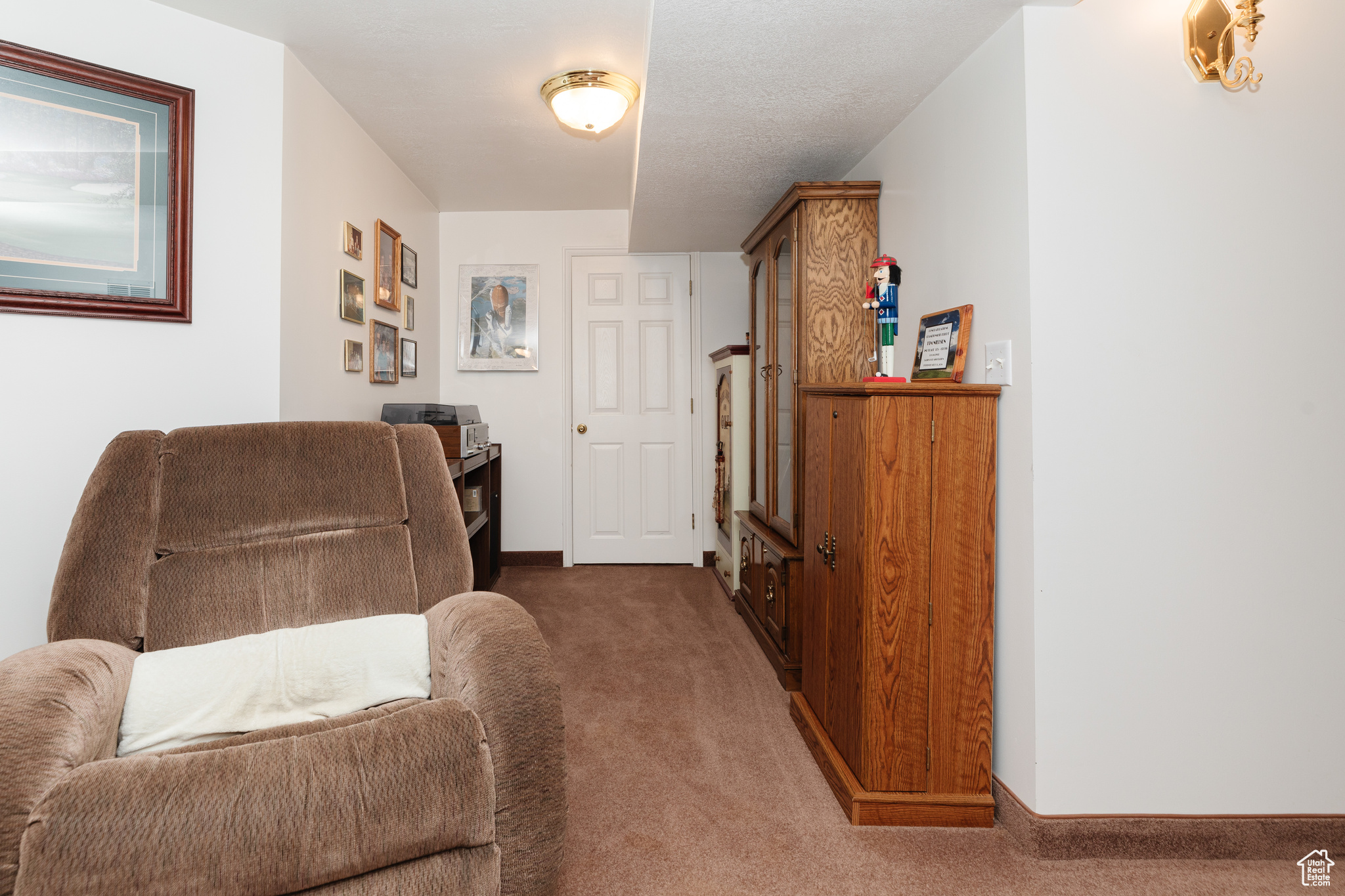 Sitting room featuring dark carpet