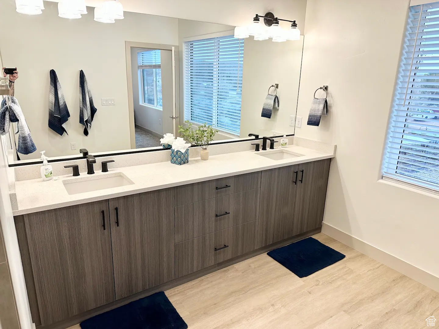 Bathroom featuring dual vanity and hardwood / wood-style flooring