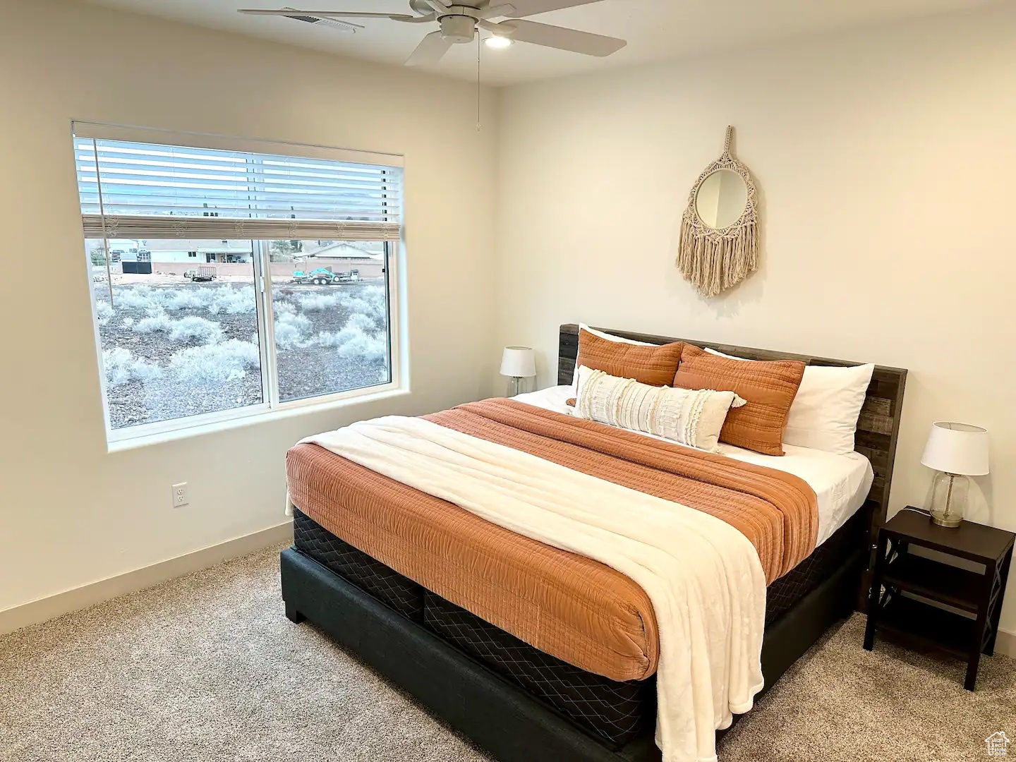 Carpeted bedroom with ceiling fan