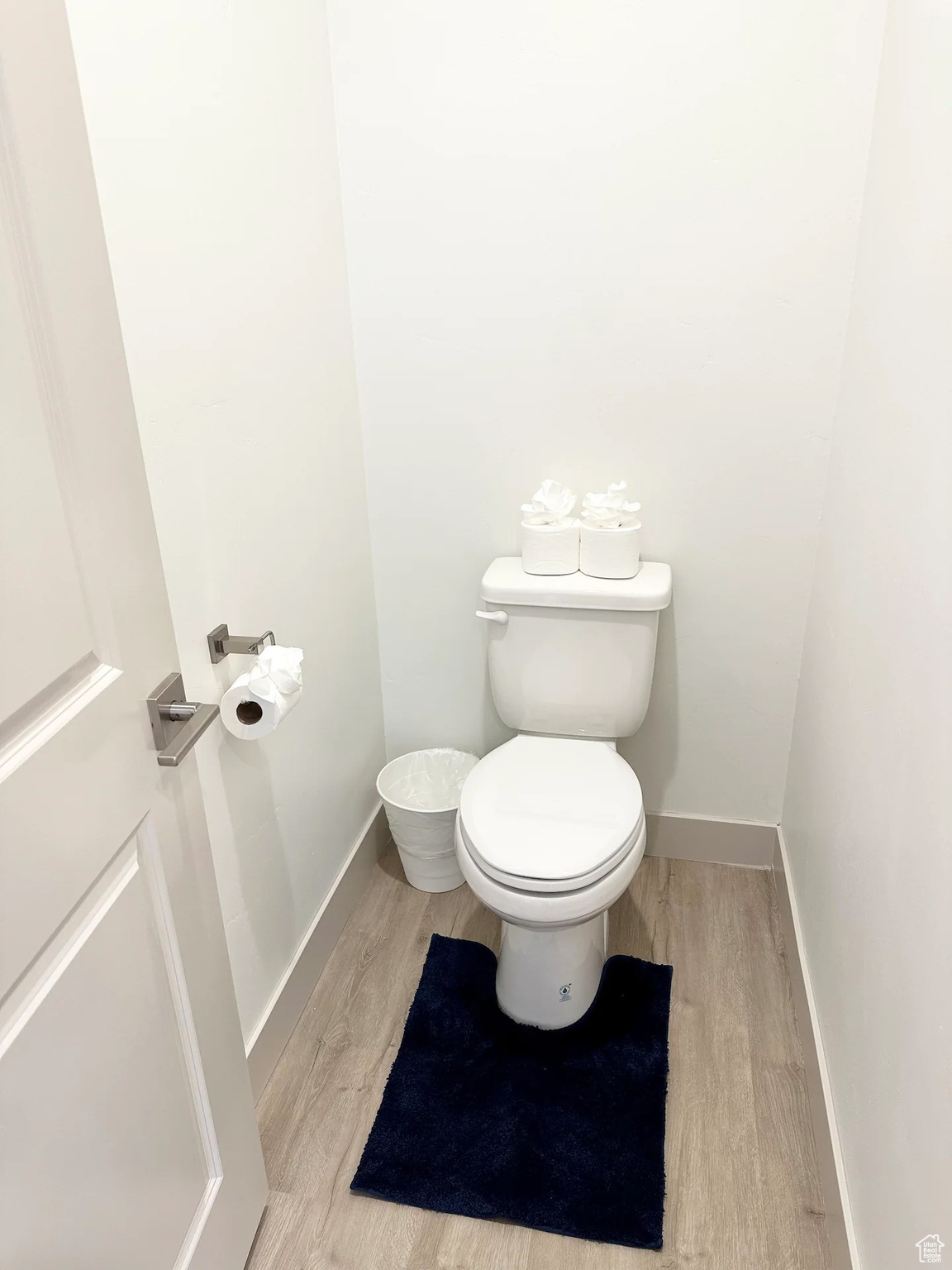 Bathroom featuring hardwood / wood-style flooring and toilet