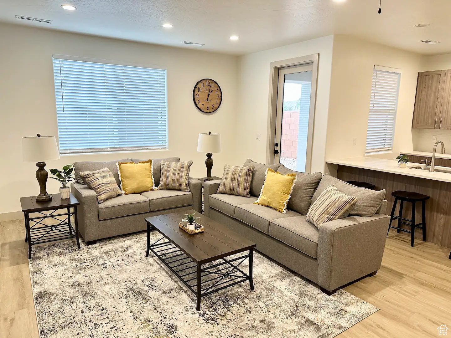 Living room with sink and light hardwood / wood-style flooring