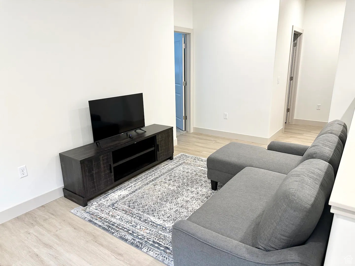 Living room with light hardwood / wood-style floors