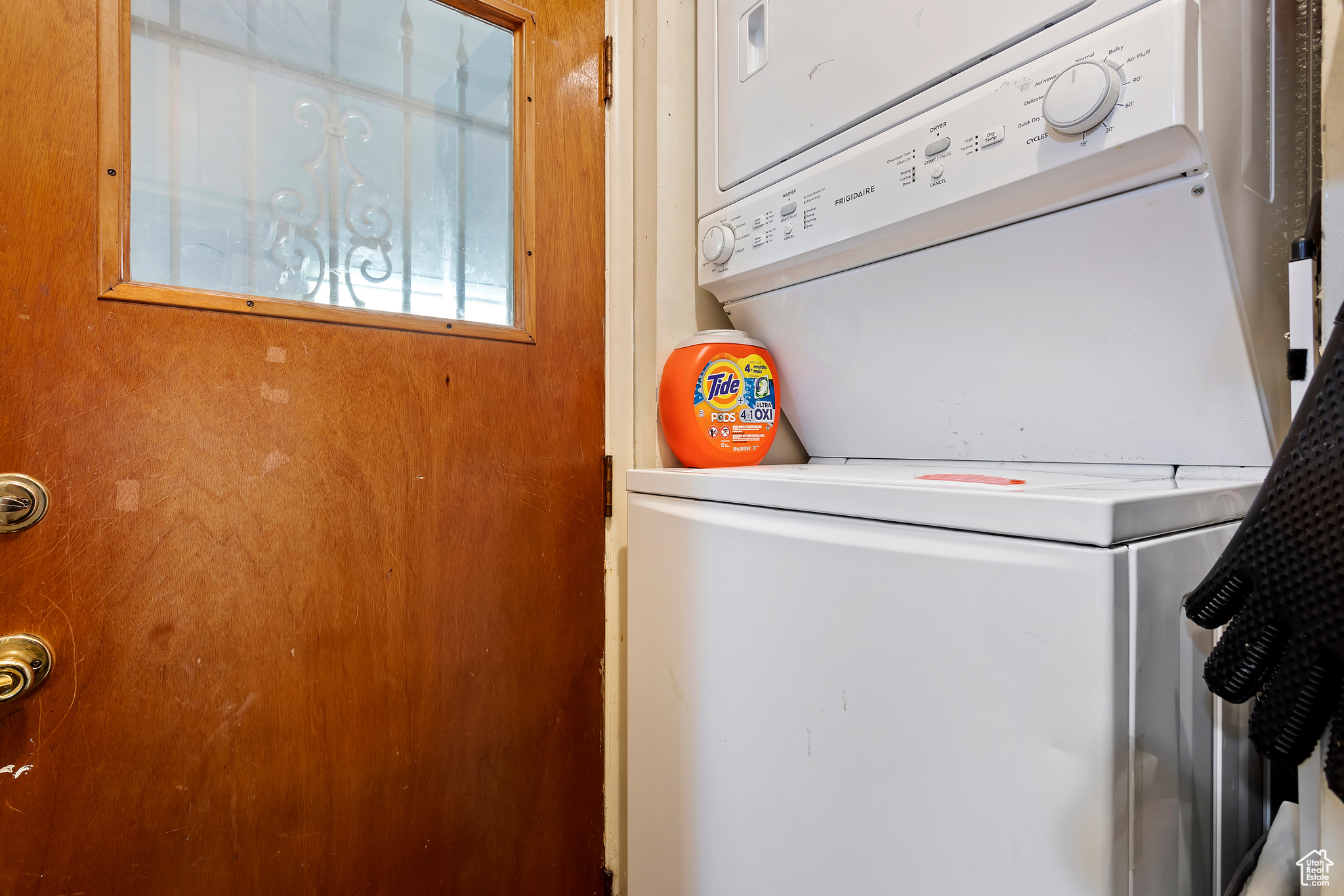 Washroom with stacked washer and clothes dryer