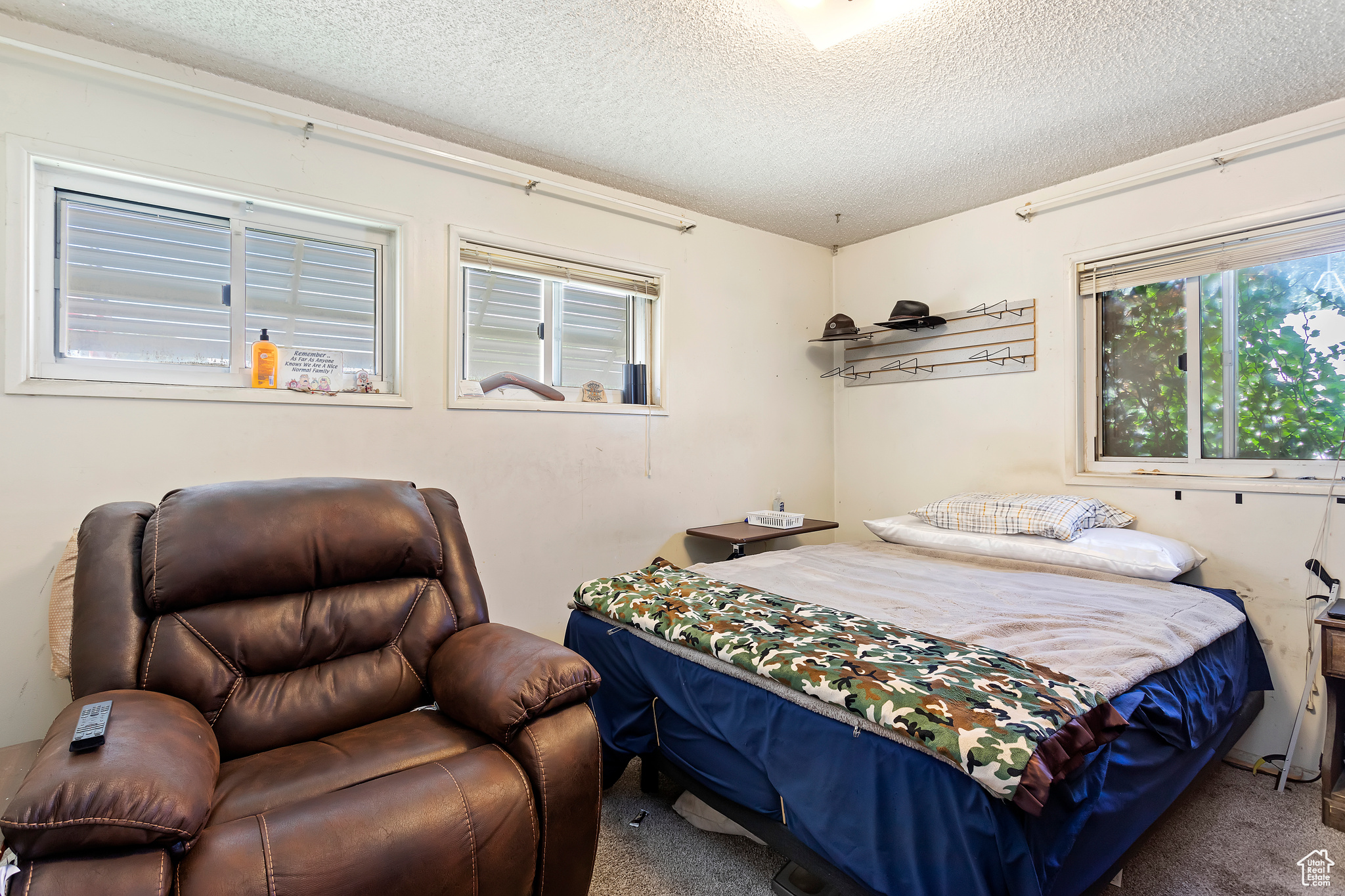 Bedroom with carpet flooring and a textured ceiling