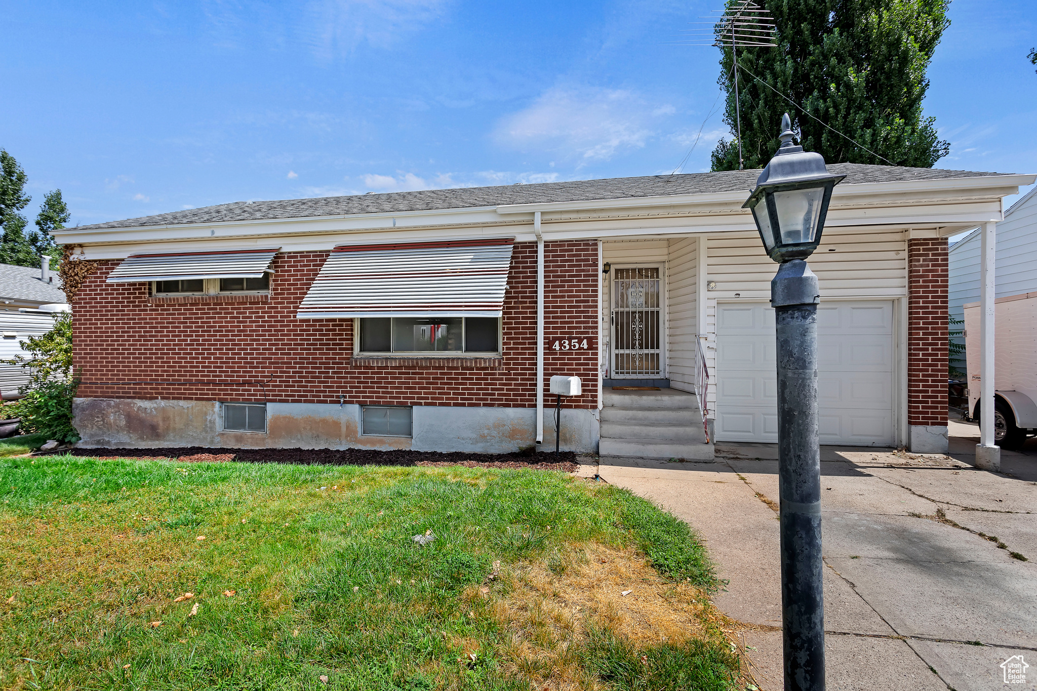 View of front of home featuring a garage and a front lawn