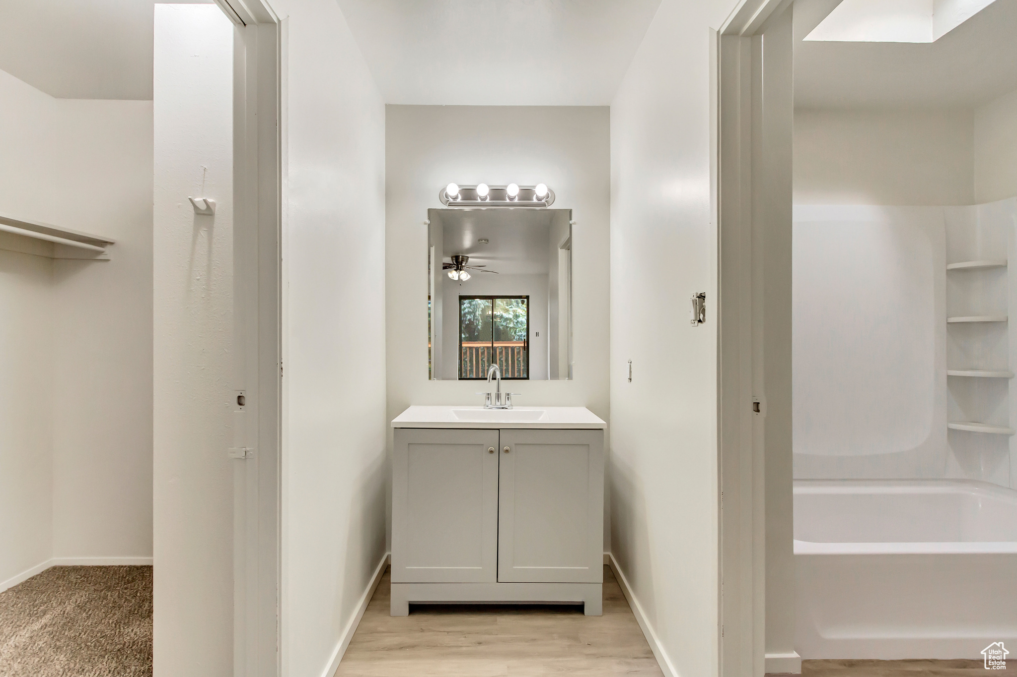 Bathroom with ceiling fan, vanity, and hardwood / wood-style flooring