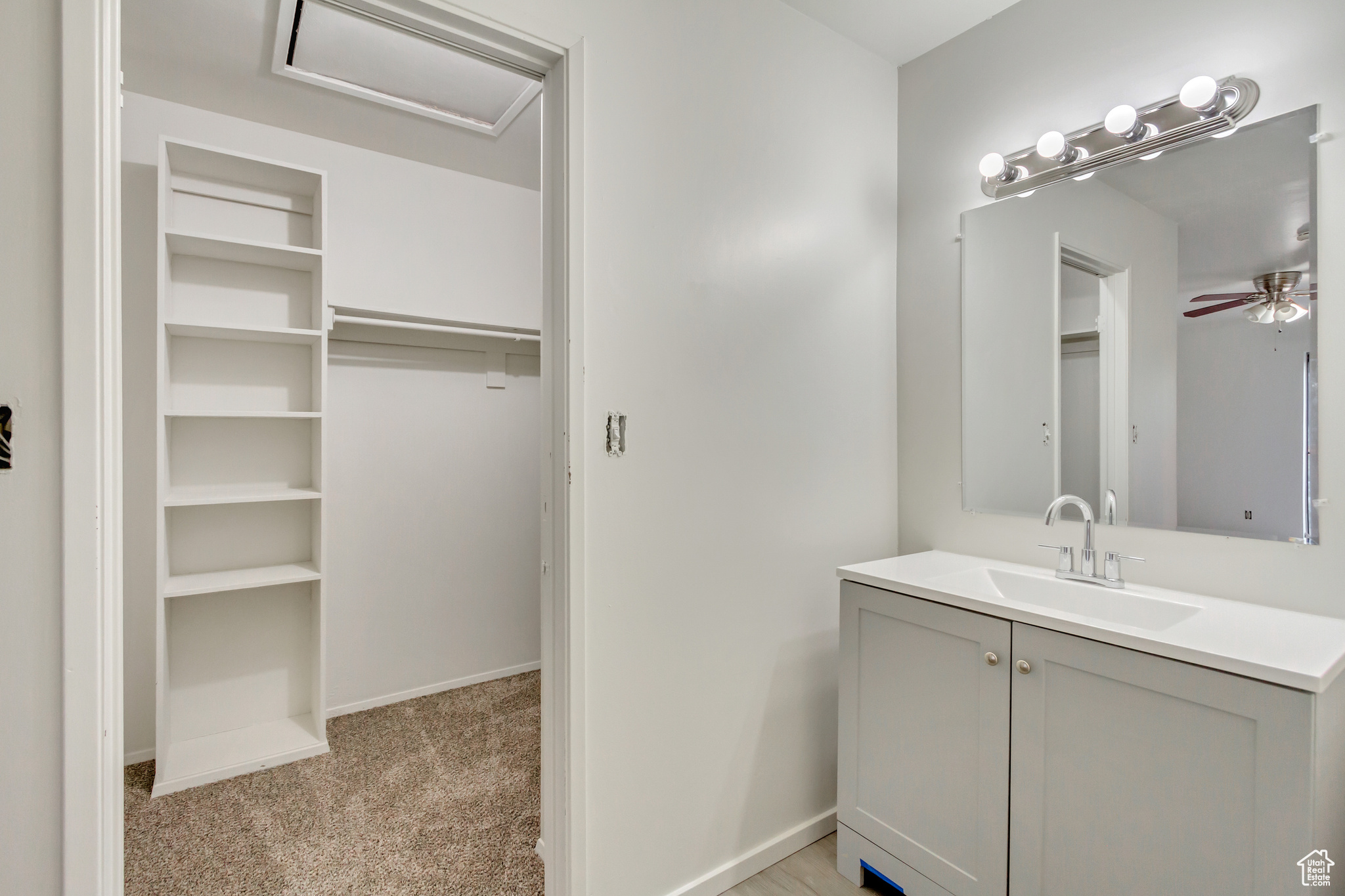 Bathroom with vanity and ceiling fan