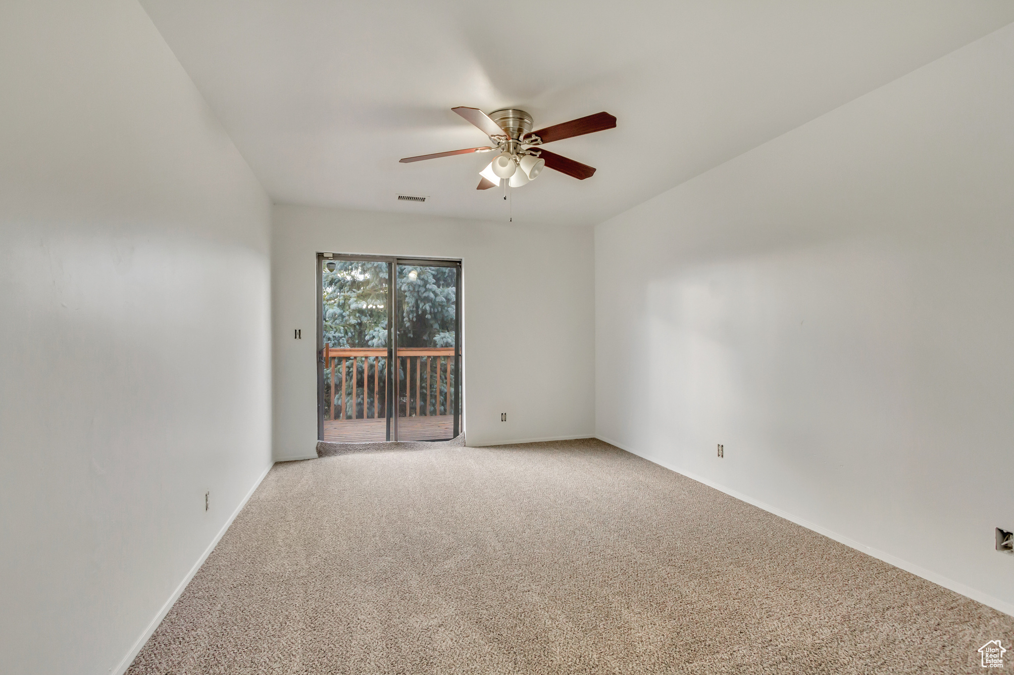 Unfurnished room with ceiling fan and carpet floors