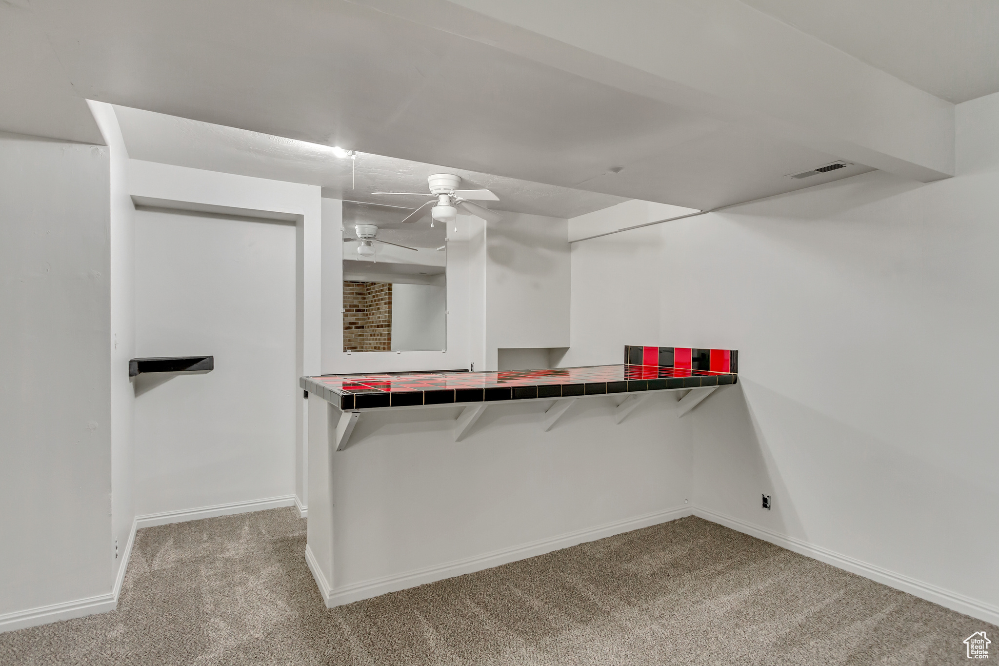 Walk in closet featuring ceiling fan and light carpet