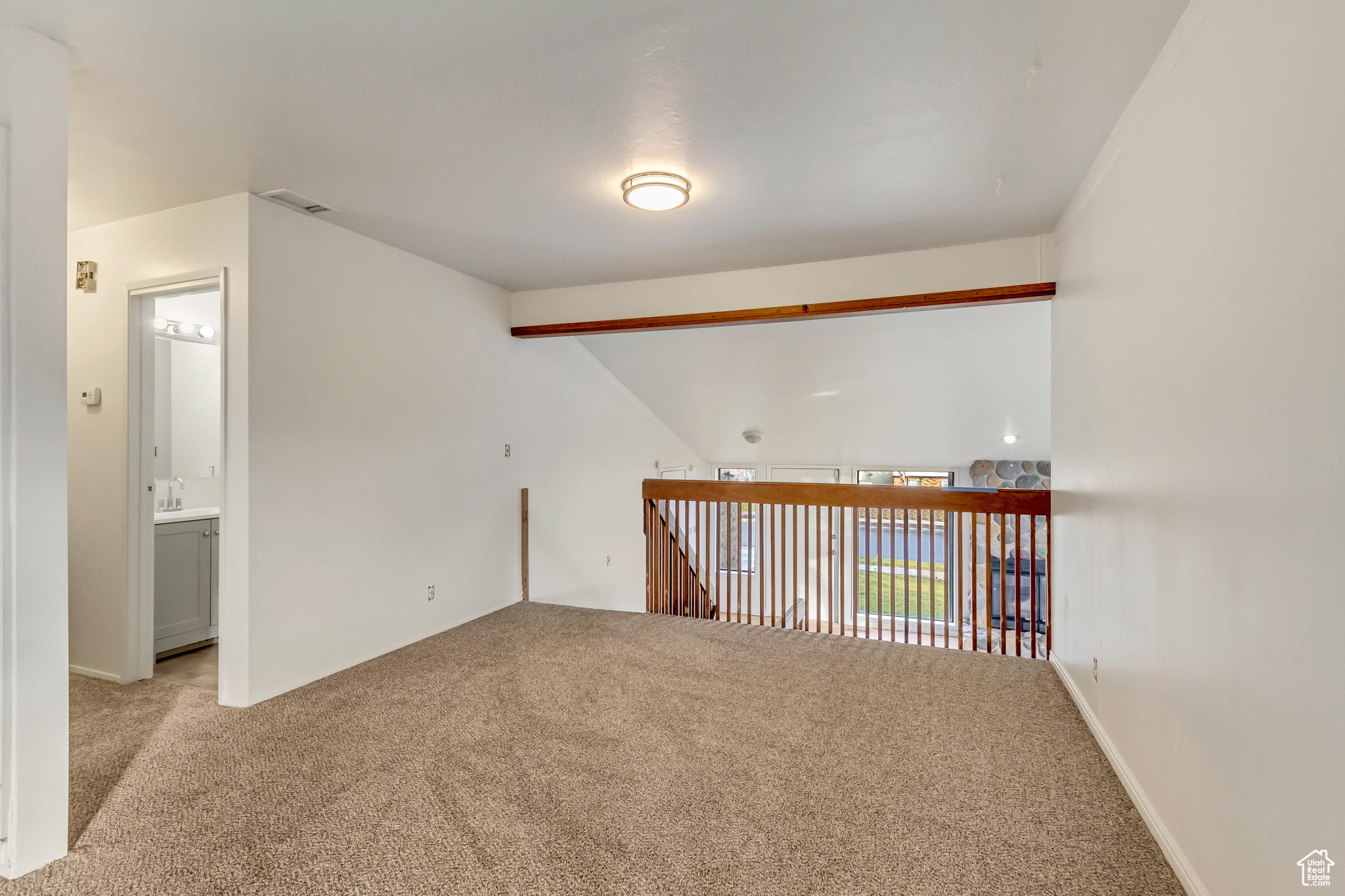 Empty room featuring light colored carpet