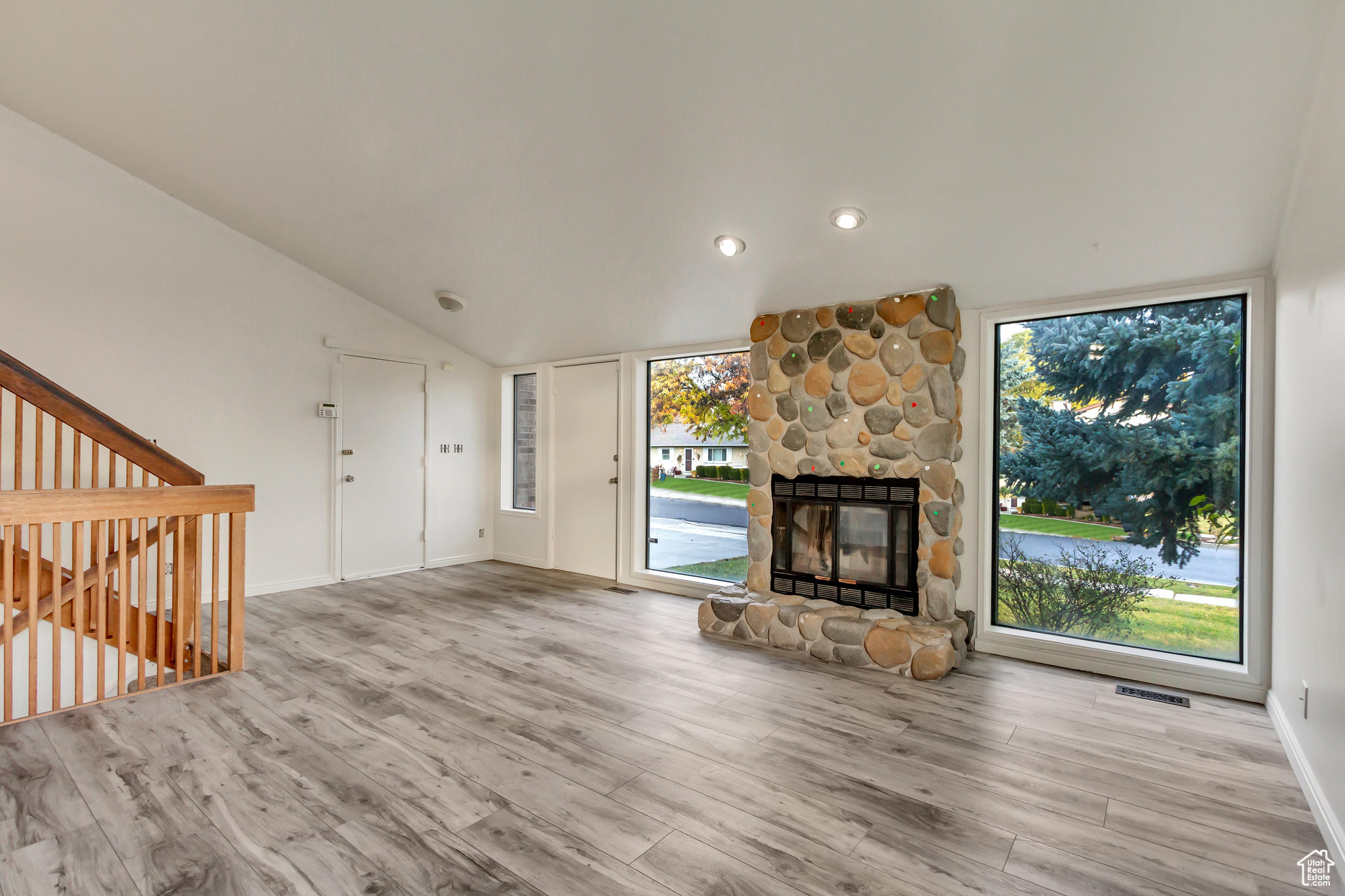 Unfurnished living room featuring light hardwood / wood-style flooring and plenty of natural light