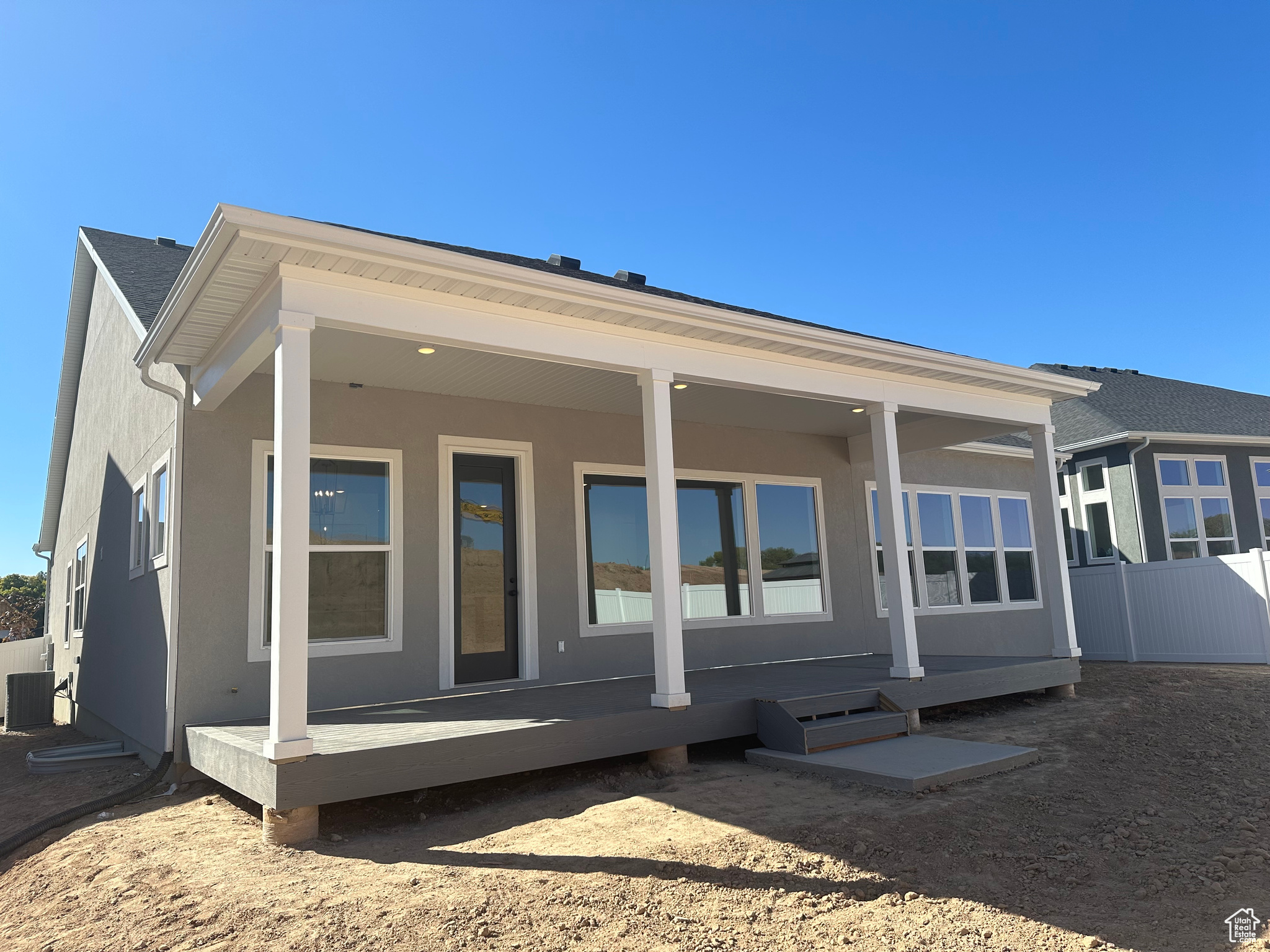 Rear view of house with a wooden deck and central air condition unit