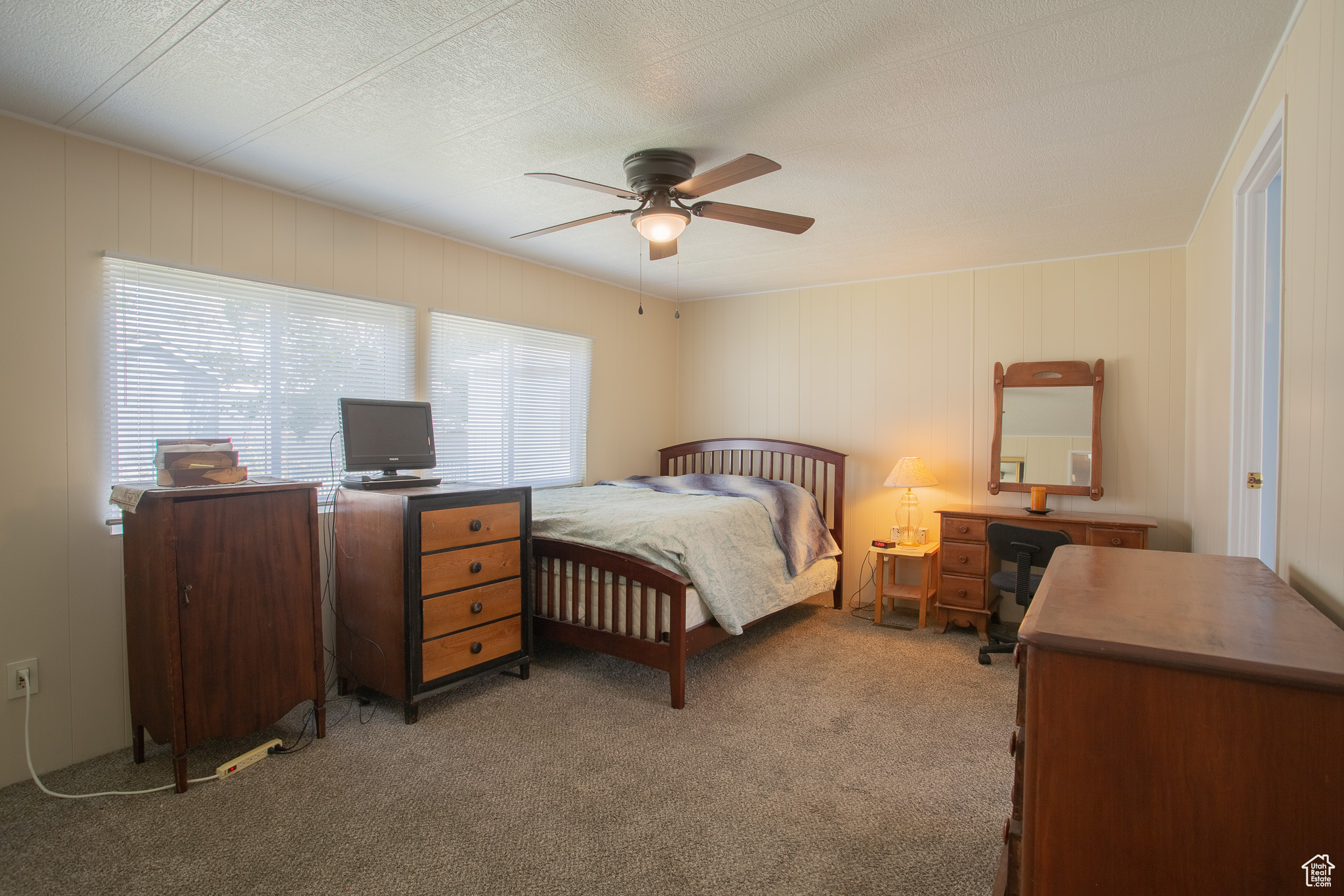 Carpeted Master bedroom featuring a ceiling fan