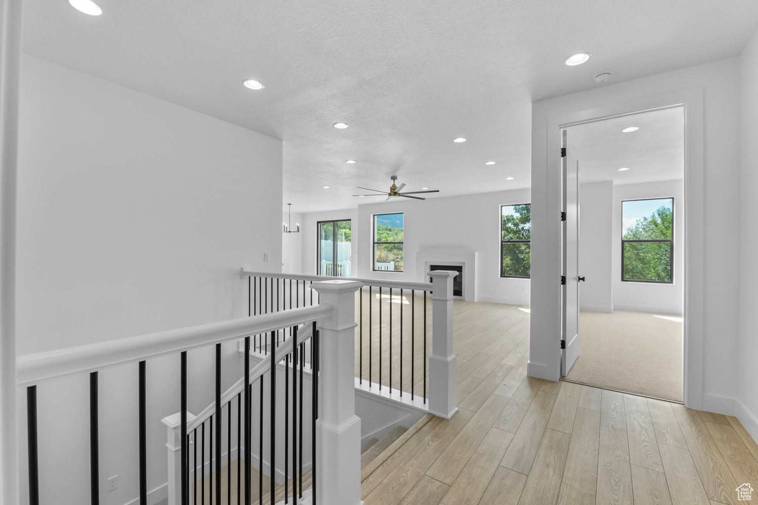 Hall featuring light hardwood / wood-style floors and a textured ceiling