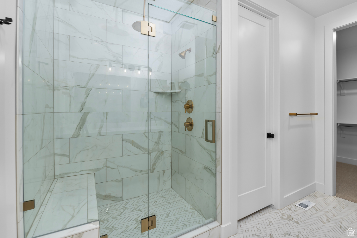 Bathroom featuring walk in shower and tile patterned flooring