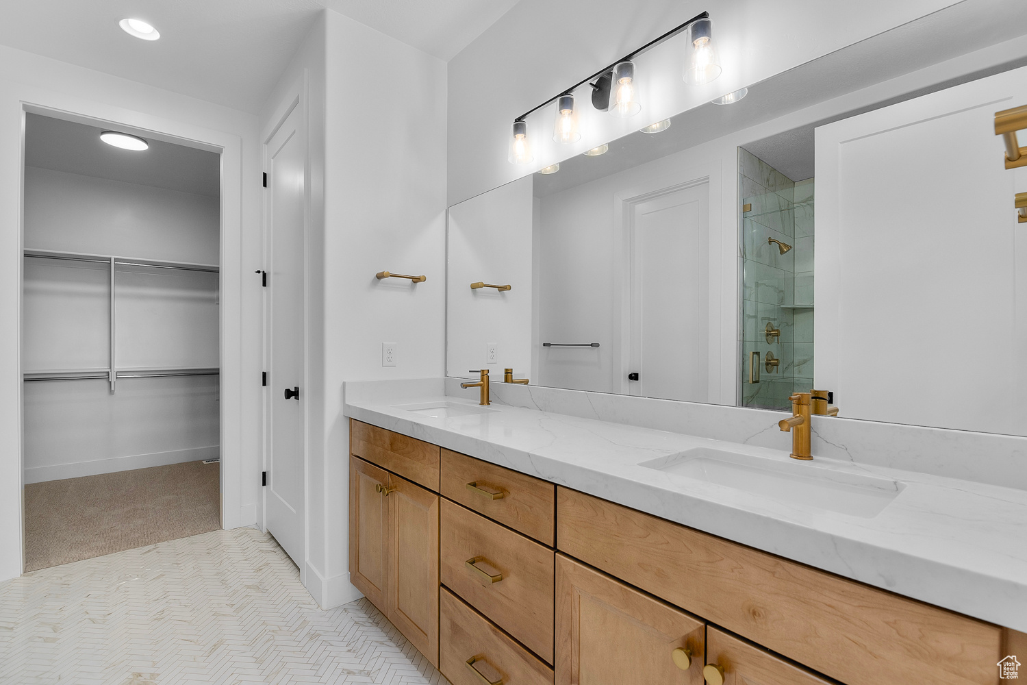 Bathroom with vanity and a shower with door