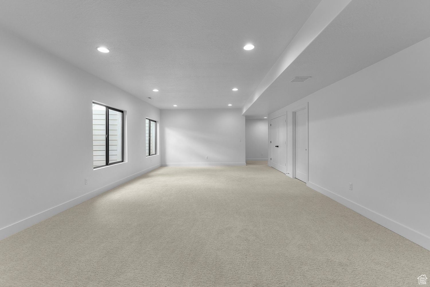 Empty room with light colored carpet