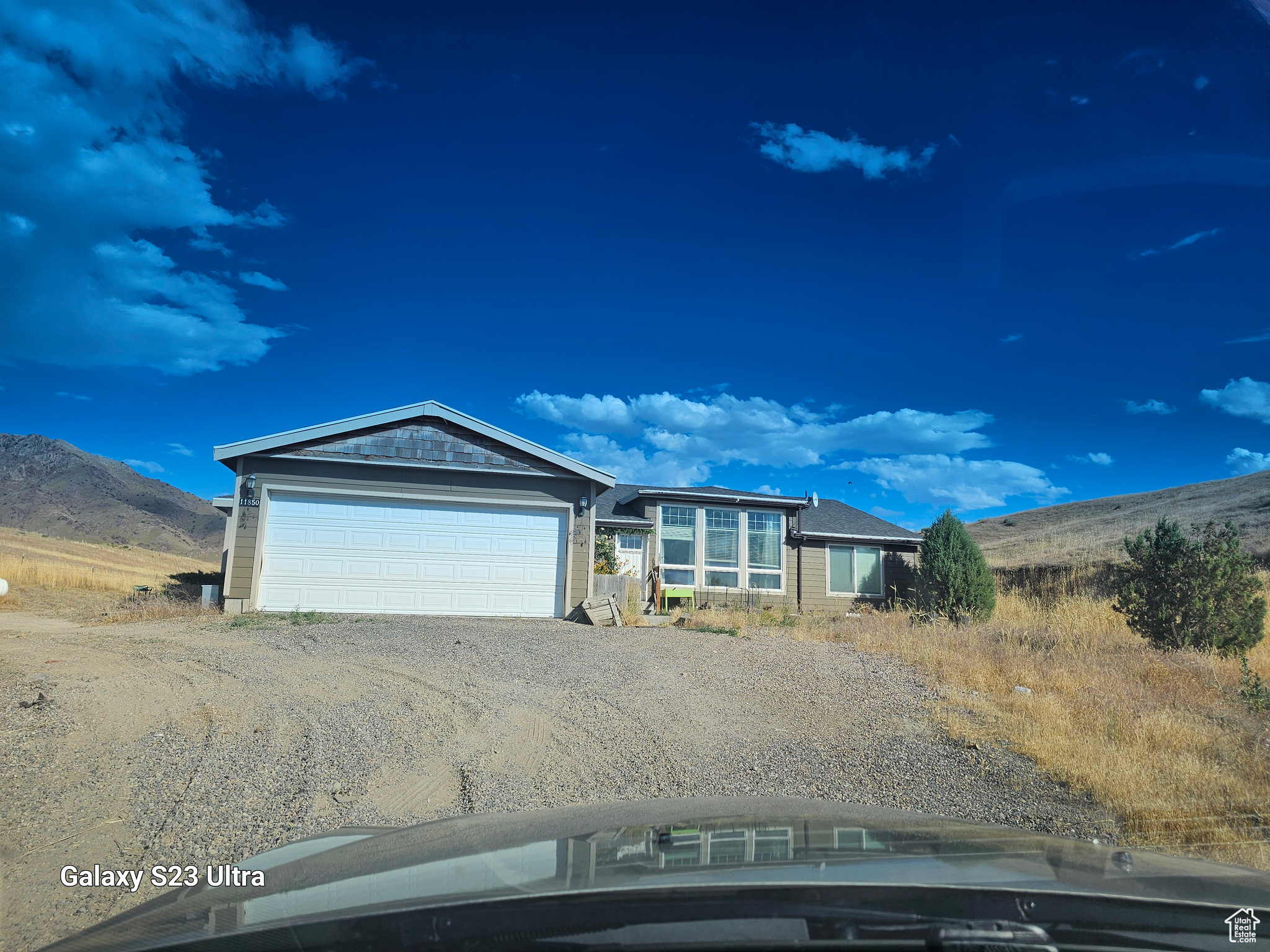 View of front of home #3 with a mountain view and a garage.