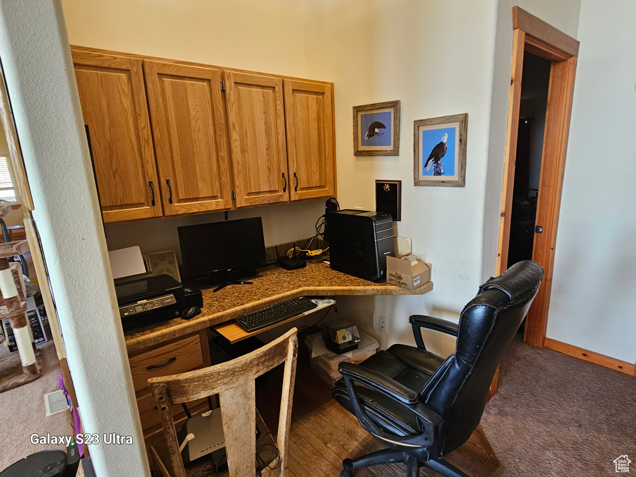 Carpeted office featuring built in desk